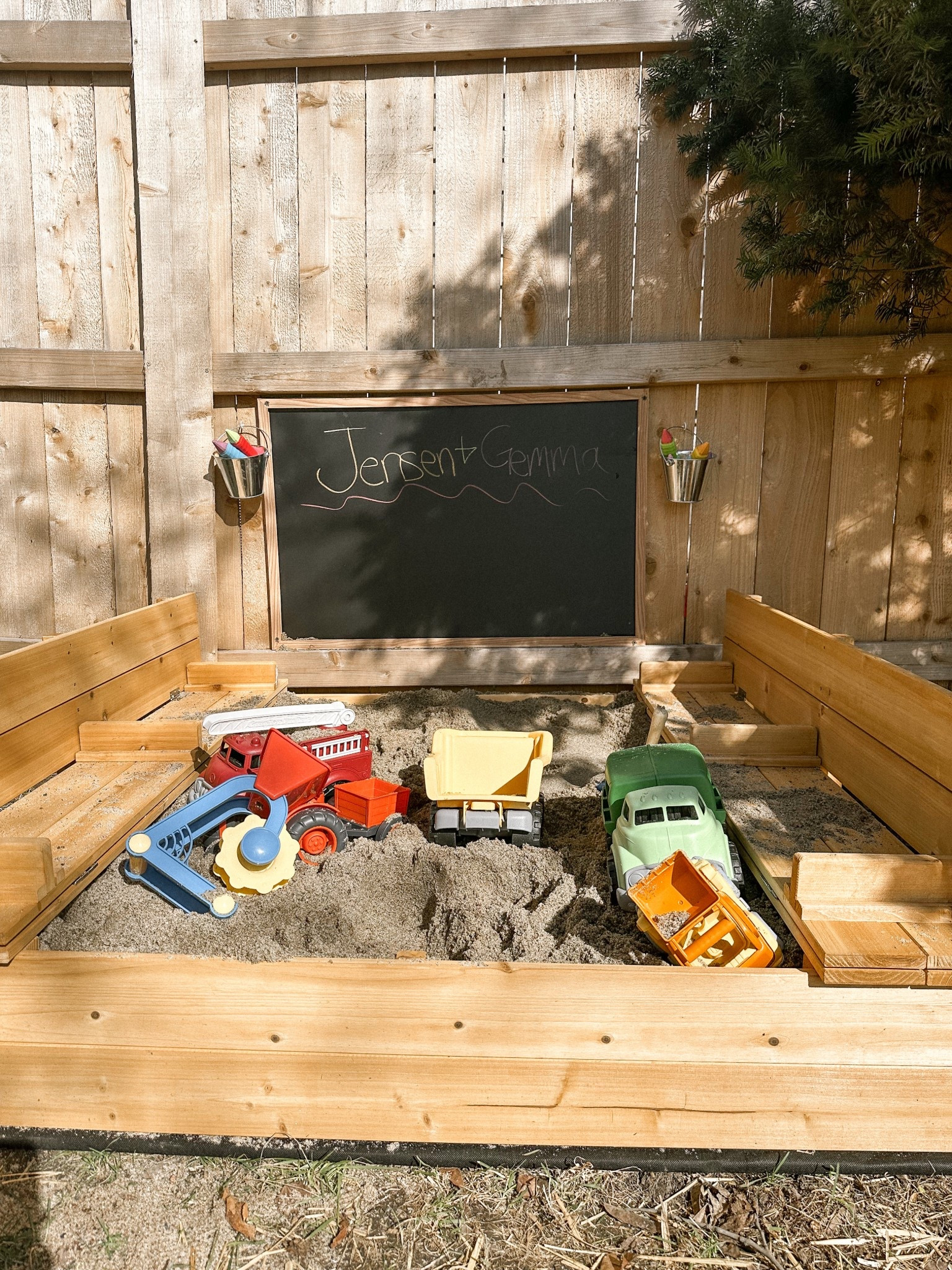 Simple little play area in our backyard! 

This Amazon sandbox was so easy to put together! The seats unfold into a lid to protect against critters. 

It comes with a tarp for the bottom. We ended up stabling the tarp to a piece of treated plywood that we then attached to the bottom of the sandbox to keep the sand in on uneven ground. 

It took 15 bags of sand to fill. 

The chalk board I got from Michael’s. I sprayed it with an outdoor sealer so it lasts. I also got these cute little buckets that hang on little screw in hooks to hold chalk and can be easily taken inside. 

This project was quick and easy and will hopefully be great entertainment for the kids all summer long. 

Linking some of our favorite toys too  

#LTKKids #LTKFamily #LTKHome