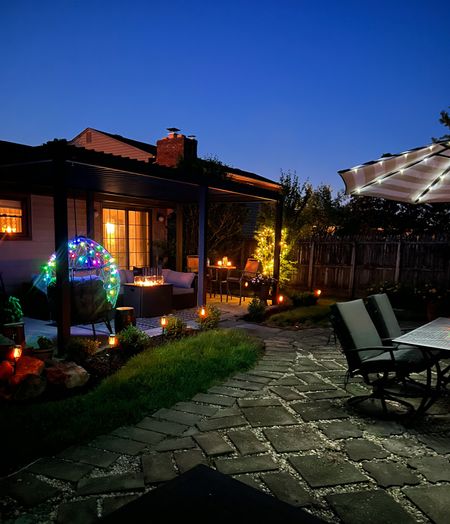 Outdoor patio views - Aluminum pergola with louvres is from Wayfair but also found on Amazon - 8 feet umbrellas with solar lights - egg chair - battery operated string lights - solar torch pathway lights - patio furniture - summer yard - patio decor - patio vibes - Amazon Home - Amazon vibes 



#LTKhome #LTKSeasonal #LTKunder100