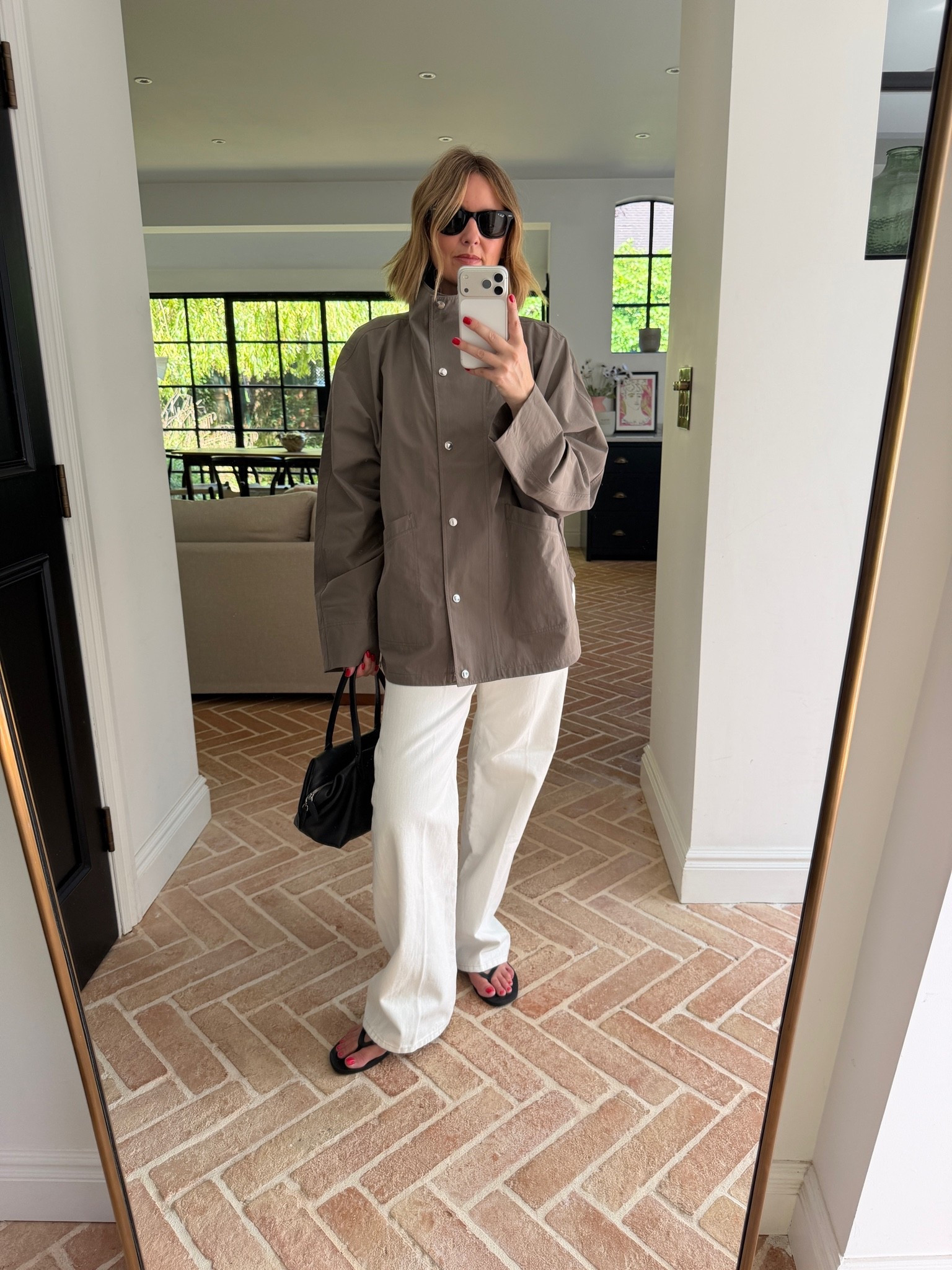 taupe utility jacket, oversized field jacket, snap button jacket, cotton twill jacket, white wide leg pants, ivory trousers, relaxed white denim, black leather tote, structured handbag, black flip flops, thong sandals, black sunglasses, neutral tonal outfit, transitional layering, spring outerwear, quiet luxury, elevated basics, effortless chic, minimalist off duty look, ltkstyletip, ltkseasonal, ltkf

#LTKeurope #LTKworkwear #LTKstyletip