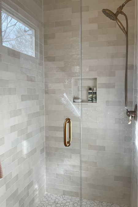 Our Home Depot artisan tile looks so expensive but it’s actually affordable.  

Ivy Hill Subway Tile.  Shower tile.  Champagne bronze shower fixtures.  Shower head.  Brass fixtures.  Hexagon Carrara tile.  Shower door.  

#LTKFamily #LTKHome