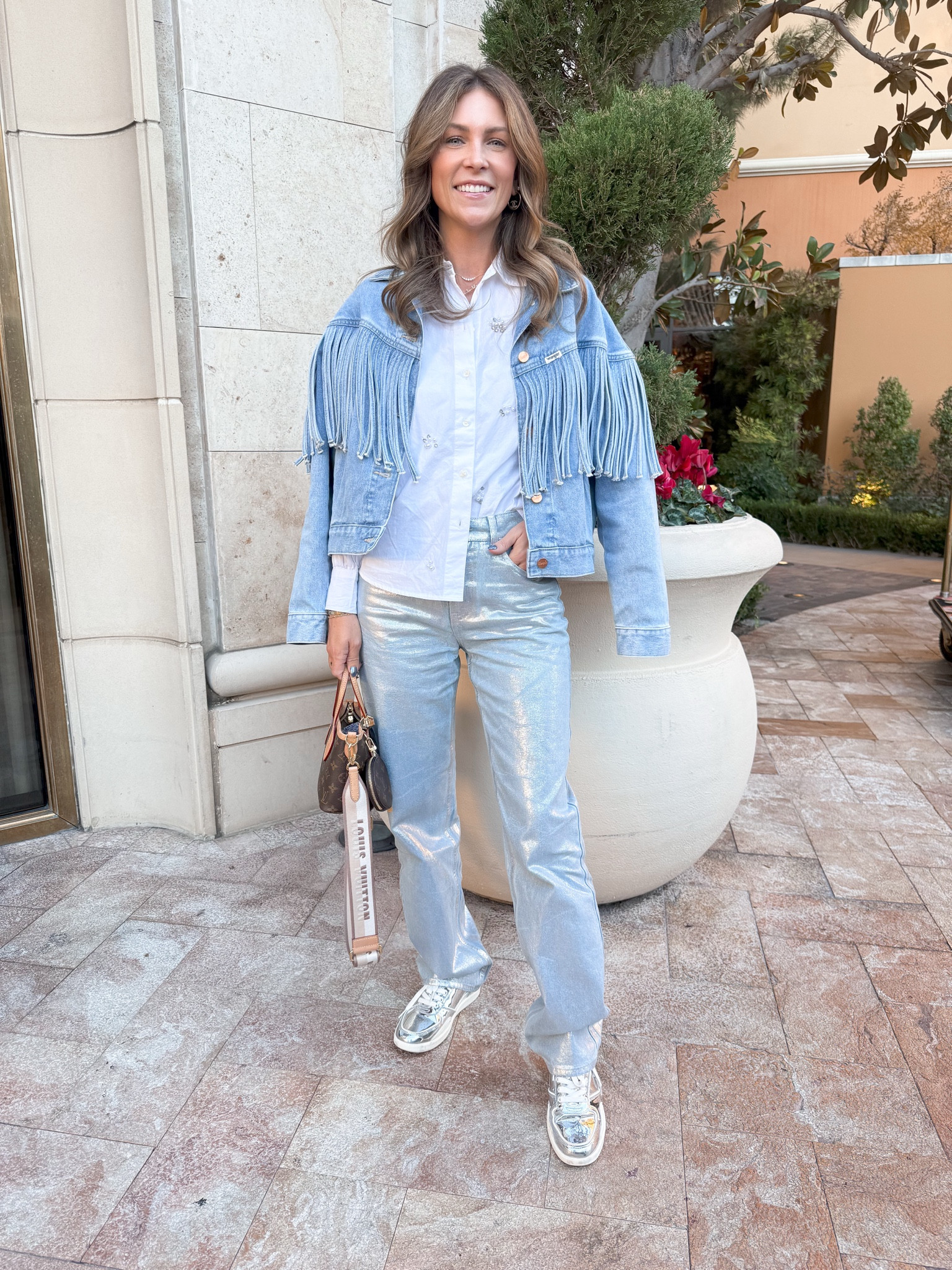 NFR Travel Outfit! 🤠 
Nordstrom jeans 
Walmart button down shirt 
Wrangler fringe denim jacket 
Tory Burch sneakers 
Louis Vuitton 

#LTKTravel #LTKStyleTip