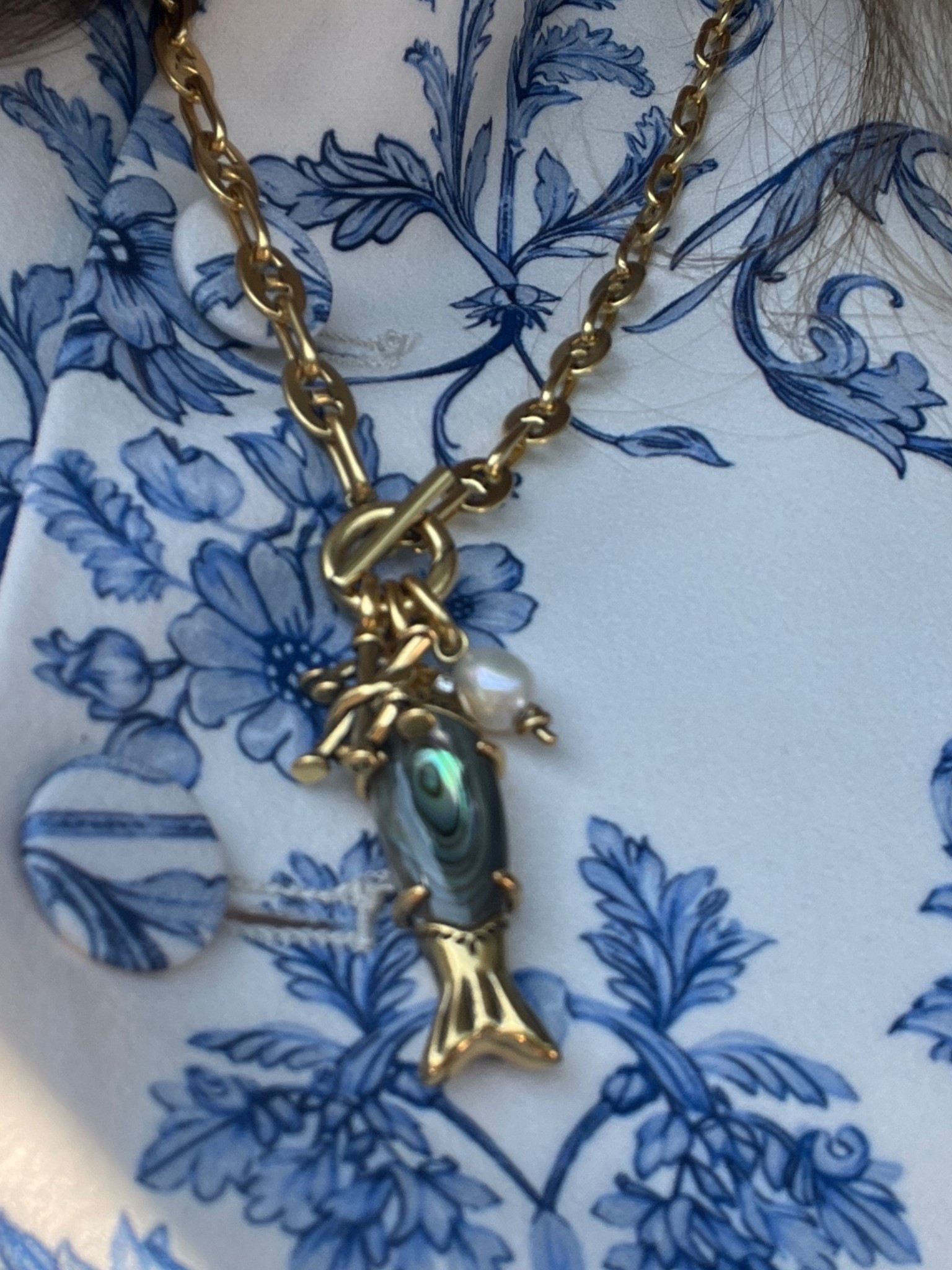 Abalone fish charm necklace that can be
Converted into a lariat.
Available in yellow and silver finish
Antique brass finish shown.

#LTKWorkwear #LTKTravel #LTKselfcare