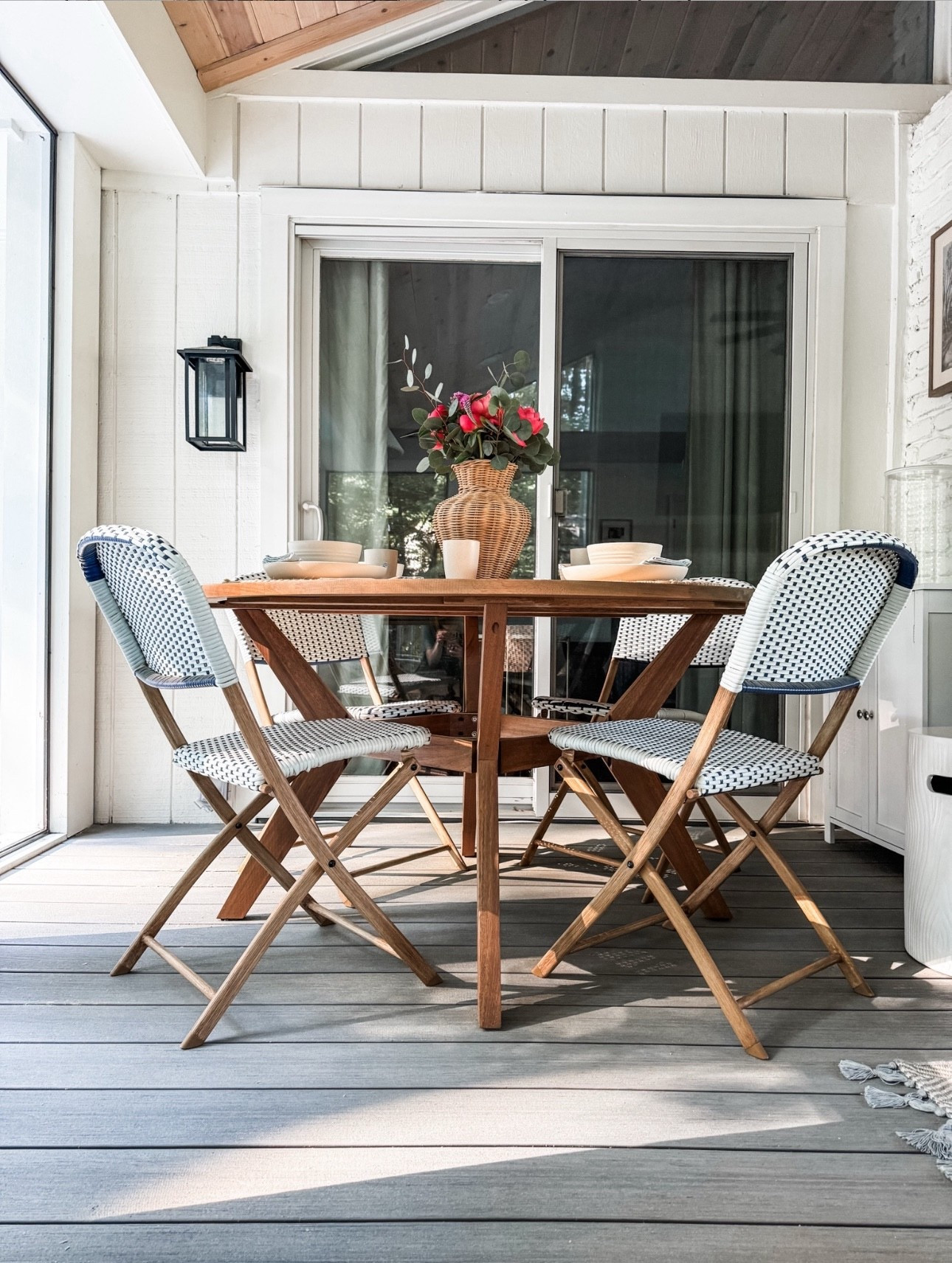 Outdoor dining done right 🤍 This outdoor dining set features a round wood patio table paired with woven bistro chairs, perfect for a cozy screened porch or covered patio. Loving the mix of natural wood furniture, woven seating, and neutral outdoor decor—from the rattan vase centerpiece to the simple place settings. An easy, timeless setup for outdoor entertaining, porch dining, and relaxed al fresco meals.

#eanesinteriors #outdoordining #patiofurniture #outdoordiningtable #bistrochairs #wovenchairs #woodtable #screenedporch #coveredpatio #outdoorliving #porchinspo #neutraldecor #alfrescodining

#LTKHome #LTKOver40 #LTKSeasonal