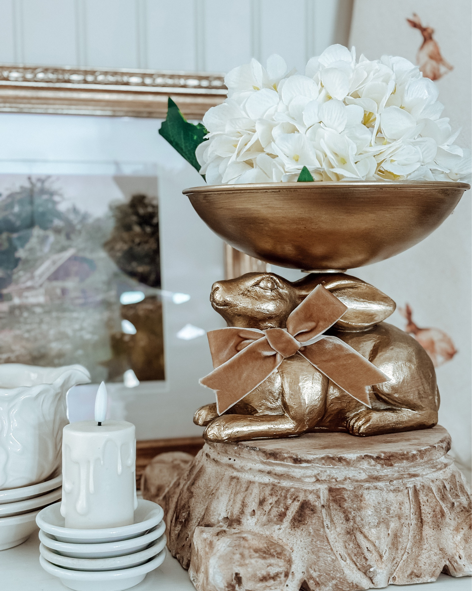 Soft spring layers with a vintage soul 🤍

This gold bunny pedestal bowl is one of my favorite pieces from our Curated Spring Collection — she’s equal parts statement and subtle charm. The warm antique finish, the velvet bow detail, the sculpted bunny base… it feels like something you’d find in an old European cottage.

Style her with florals, moss, seasonal fruit, or let her stand alone as a centerpiece moment ✨ She instantly elevates shelves, hutches, coffee bars, or dining tables.

If you love decor that feels collected, timeless, and a little bit magical… this one is special 🤍

Tap to shop before she hops away 🐇

#CraftedHiveCulture #LTKHome #SpringDecor #CottageStyle #VintageInspiredHome #HeirloomDecor #CollectedHome #NeutralSpring

#LTKSpringSale #LTKSeasonal