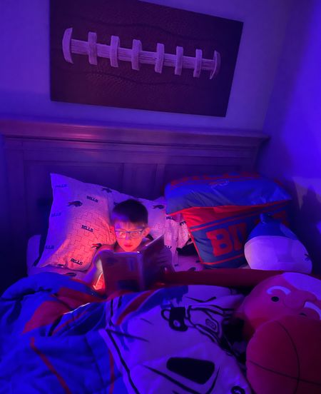 Night reading with his neck book light. We recently redecorated his room and added football & Buffalo Bills touches. 

#LTKhome #LTKkids #LTKfamily
