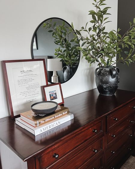 New bedroom dresser decor. pottery barn, coffee table books, round mirror, faux branches 

#LTKhome