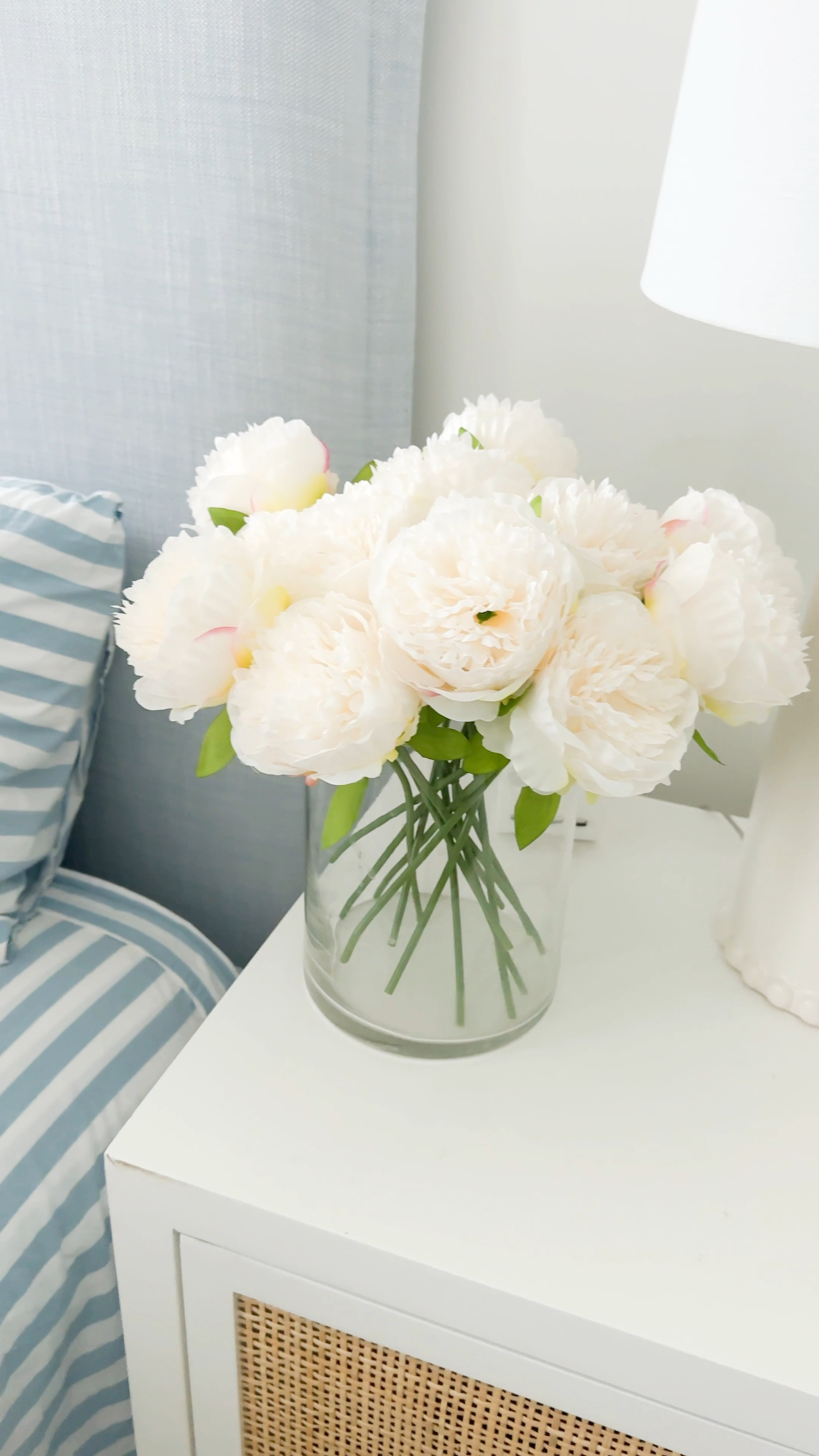 I finally pulled off our Christmas bedding today and gave our bedroom an unplanned but fresh look with blue and white striped sheets, white duvet cover, block print throw pillows and waffle knit blanket on our light blue linen bed. I also added my favorite faux peonies (mine are White not Pure White) on our cane nightstands! Also linking a look for less for our bed  and nightstands - both of which we also own! #ltkhome #ltkseasonal #ltkhome #ltksalealert #ltkfindsunder50 #ltkfindsunder100 #ltkstyletip #ltkwatchnow

#LTKSeasonal #LTKHome #LTKSaleAlert