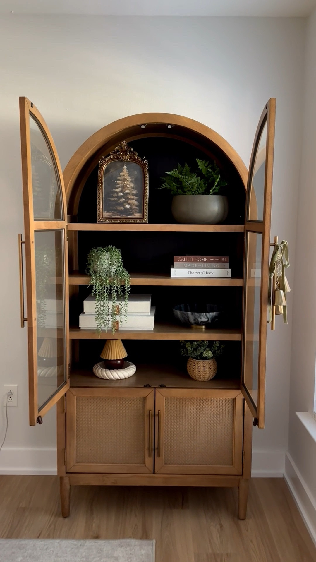 Sam’s Club viral Member's Mark Enzo Storage Cabinet With Rattan Cabinet Doors. Such good quality 

Brass 3 Bell Decorative Swag - Hearth & Hand™ with Magnolia

Antique frame, Anthro mirror look alike, gold antique frame, Christmas artwork, Christmas decor, tabletop decor, Anthropologie look alike, Christmas tree art, shelf decor, cabinet decor 

Target lampshade candle & Target marble dish

Made for Living: Collected Interiors for All Sorts of Styles book 

The Art of Home: A Designer Guide to Creating an Elevated Yet Approachable Home book 

Decorative Photo Storage Boxes with Lids - Set of 2 Linen Organizers

The marble bowl and plants are TJ Maxx 

Christmas bells with velvet ribbon are from Target!

Arch cabinet, wood cabinet, shelf styling, shelf decor, marble dish, stone bowl, bells, Christmas bells, bell decor, Christmas ornaments 

#LTKHome #LTKHoliday #LTKStyleTip