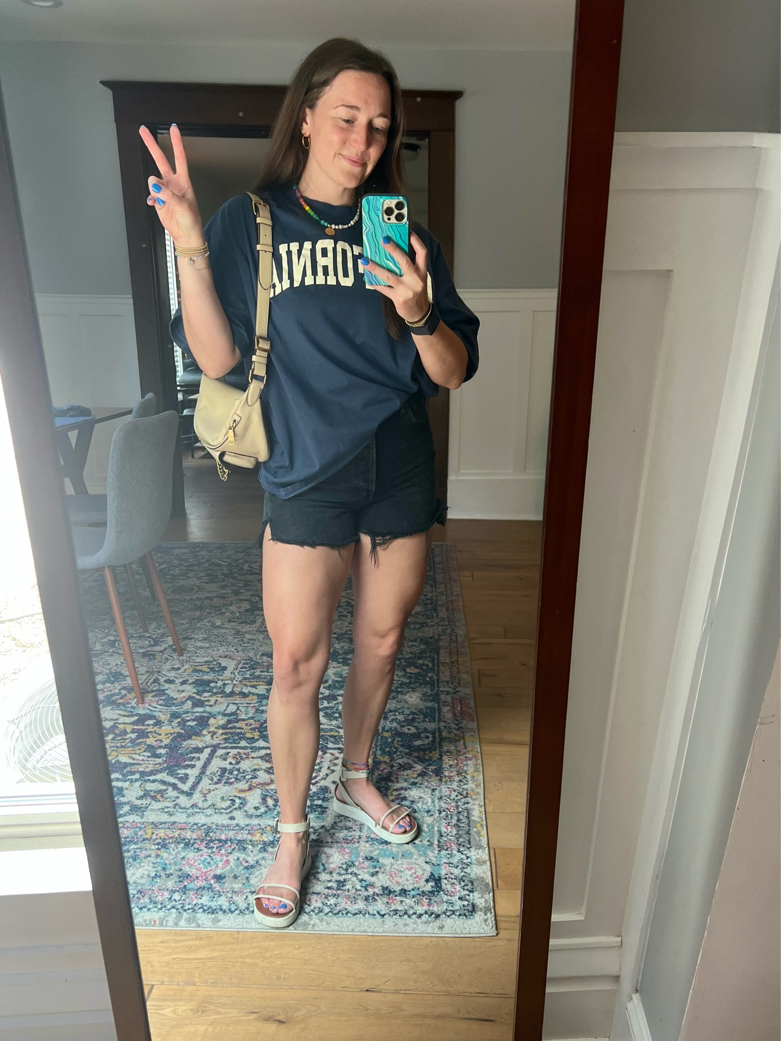 Day 16 of 30 of getting dressed with things in my closet. Casual Friday over here so pairing some AGOLDE denim shorts with an oversized tee, comfy platform sandals and colorful jewelry. 