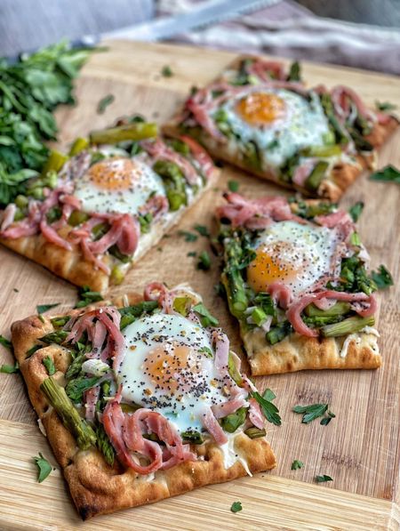 Kick your Easter brunch up a notch with this beautiful and delicious recipe!🐰 These Spring Breakfast Flatbreads are the perfect dish to serve at Easter or any spring gathering.

Far from your average breakfast, these bright and vibrant flatbreads will impress all your guests. Plus, they're easy enough to make and reheat for breakfast all week!

Mozzarella cheese, fresh asparagus, ham and a runny egg top these delicious flatbreads, making it a filling breakfast, lunch, or brunch option.
Full recipe on www.sweetsavoryandsteph.com 

#LTKhome #LTKSeasonal