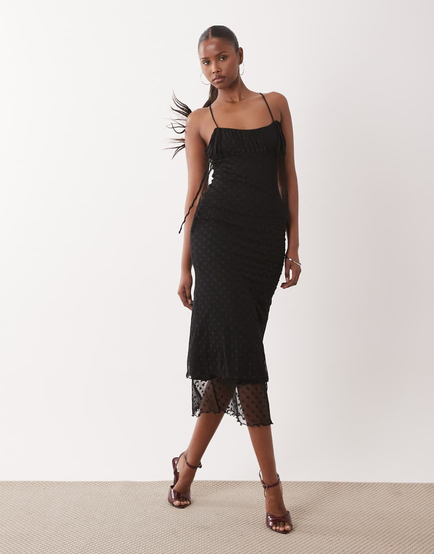ASOS DESIGN awkward length dobby mesh slip dress with ruched bust and peek a boo hem detail in black | ASOS (Global)