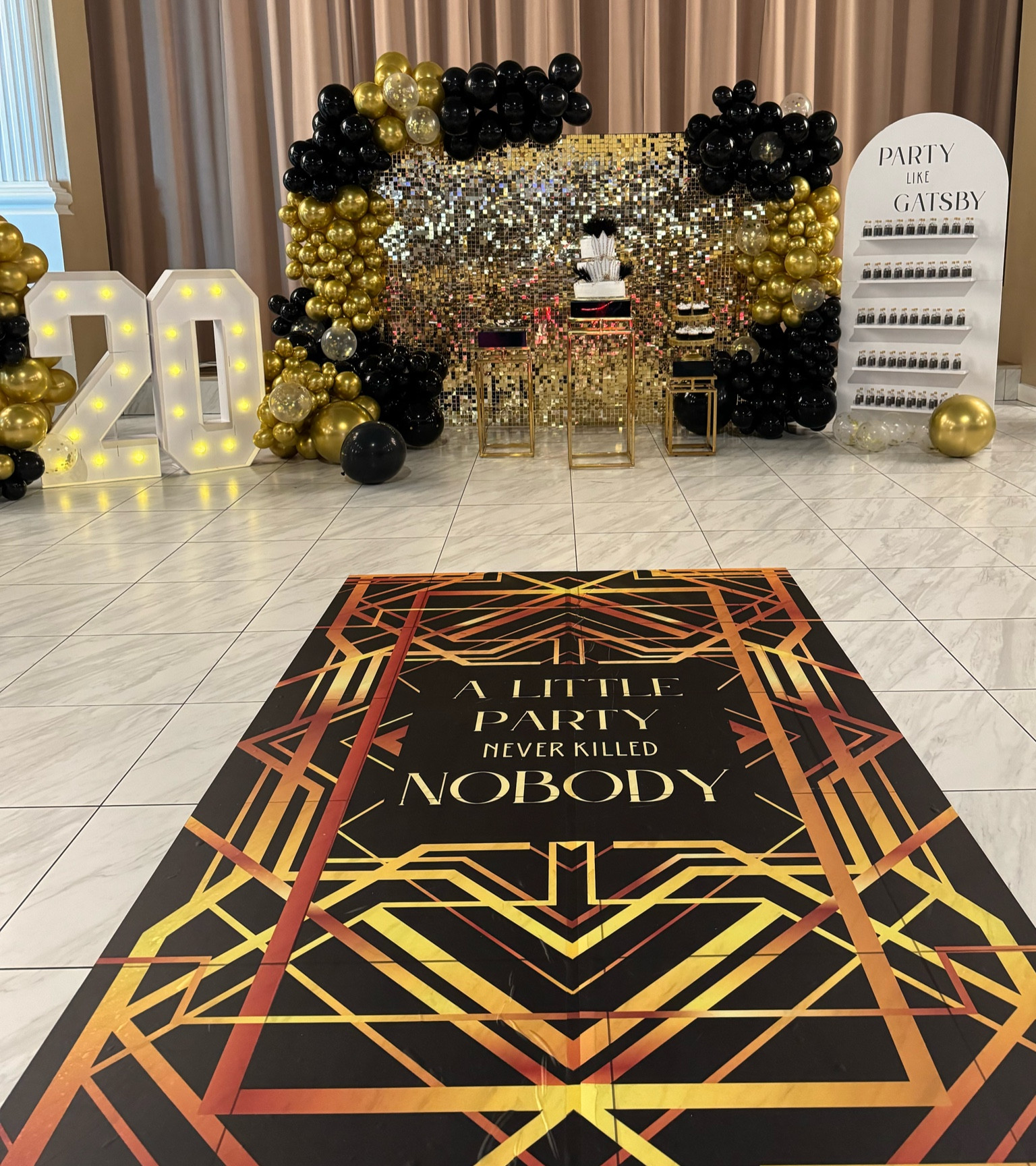 Great Gatsby/ Roaring 20s themed party main decor 
The marquee numbers are 4ft tall 
Used 4 packs of the balloon arch kit
Multi-shelf stand rental from IG: @ abpartyrental 
Gold and black tables rental from IG: @ bee_event_rentals 
Dance floor decal from bestofsigns.com 

#LTKparties