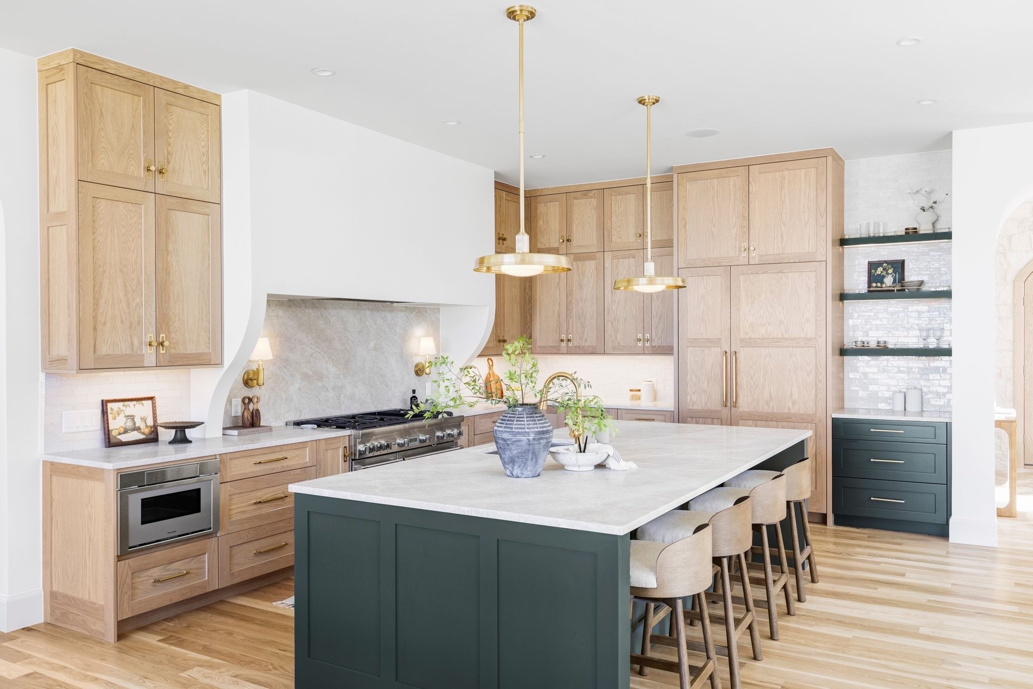 Warm, organic-modern kitchen with a mix of white oak cabinetry and a dark island with cream and wood swivel bar stools 

Island, stools, designer kitchen, organic kitchen

#LTKHome