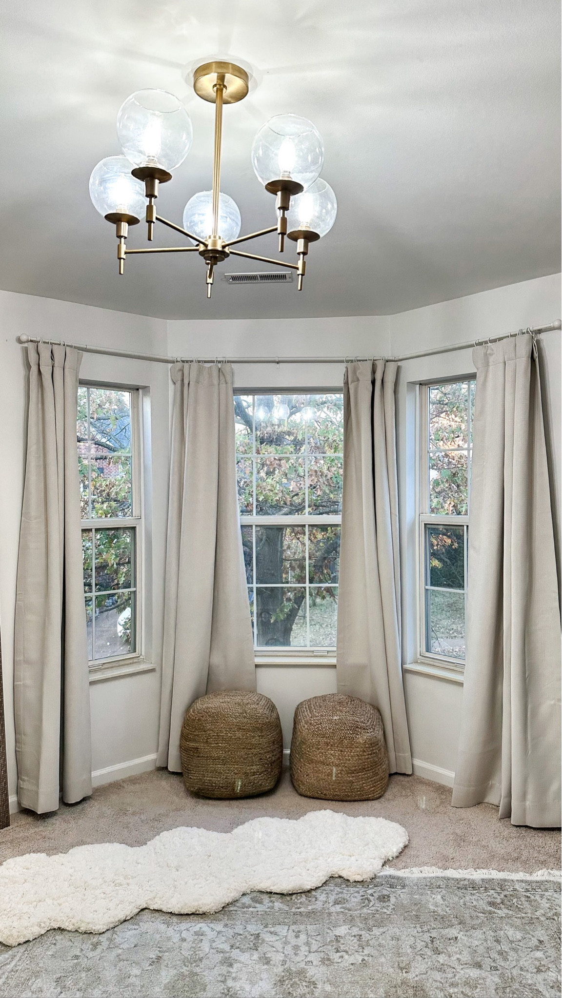 Gold light fixture
Light tan curtains beige curtains off white from Amazon half price drapes affordable curtains 
White curtain rod under $30 Walmart find 
Rattan jute poufs natural poufs 
Gold chandelier 

#LTKstyletip #LTKhome #LTKunder100