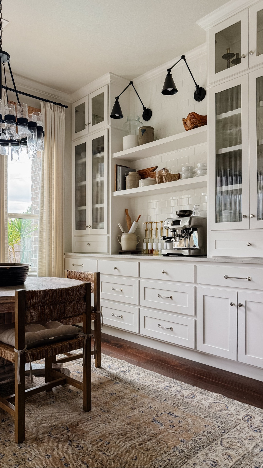 Our kitchen nook built-ins with polished nickel knobs, black library sconces, espresso machine, woven dining chairs, and antique round dining table

The built-ins feature installed reeded glass. You can get a similar look using reeded glass film. Linking to that option below.



#LTKHome