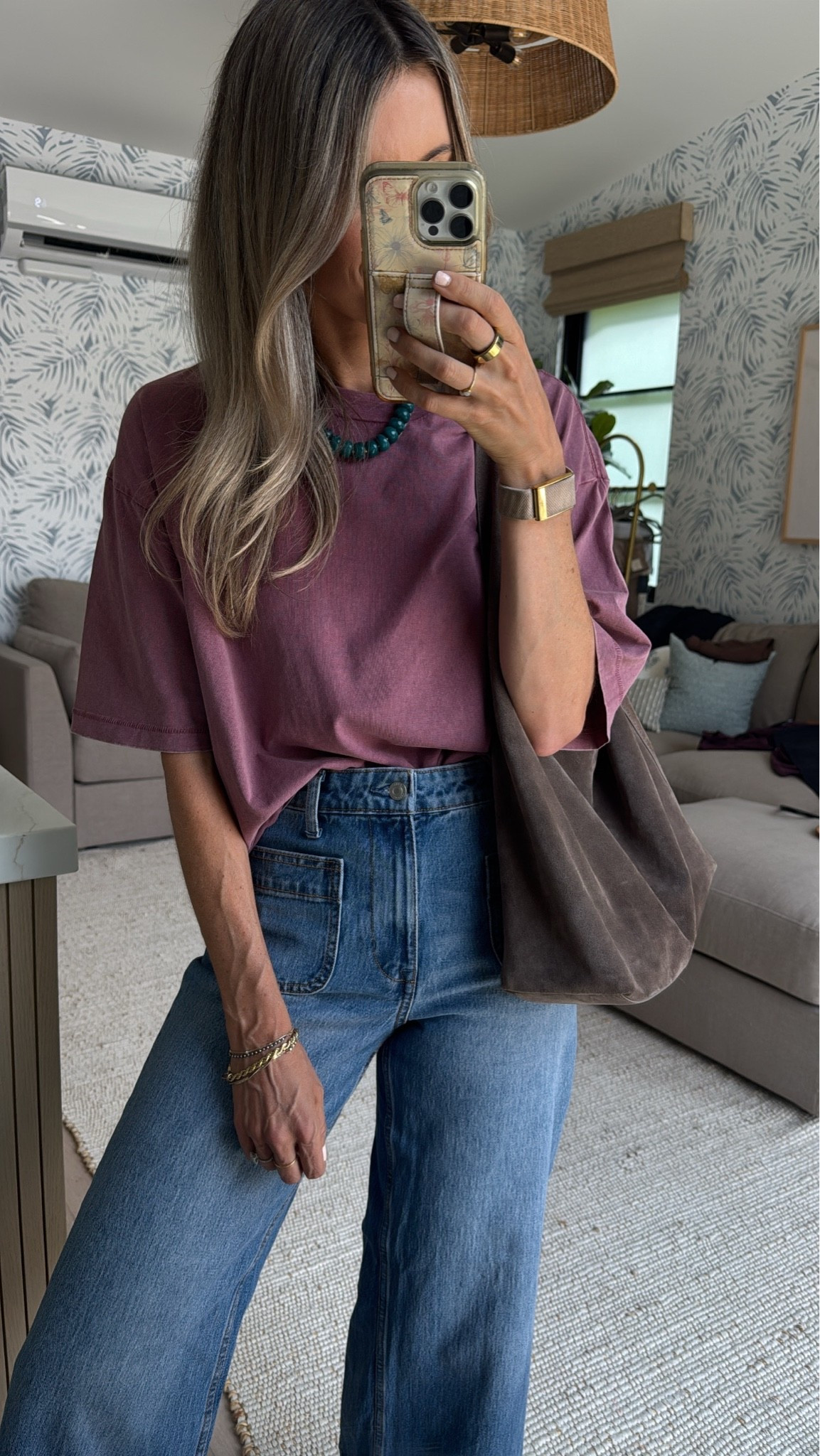 I kept seeing women wearing T-shirts like this and every time I buy one it wasn’t the same oversized fit and I finally realized people are buying from the men’s section. This men’s tee is only nine dollars and I’m wearing a size small my normal size. 
I’ll link a couple others that I know are a similar fit that I love. 
￼
And this pair of denim is so so so cute and on clearance for $20! Add a colorful necklace to complete the look. This one’s on sale for $10. And then my bag is the only bag you need for fall! I love the slouchy style of it. ￼