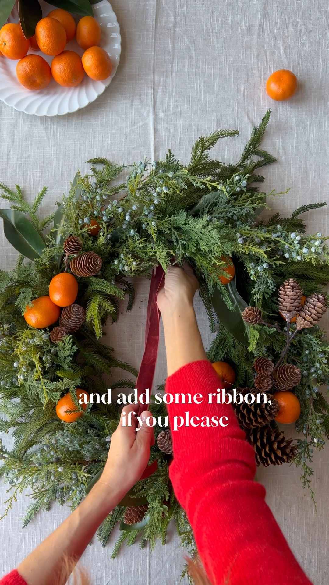 Cuties 🍊, mandarins, kumquats—whatever your grocery has fresh. I have a faux evergreen wreath I re-use every year and I’m kind of obsessed with adding citrus to it! 
The scent was amazing as I was attaching these, and I can only imagine how the combination of a FRESH evergreen wreath + citrus would smell! Gah!

To attach the citrus, thread 18-gauge floral wire through the center and twist the wire ends together closely around the fruit to hold it in place.Then wrap the wire ‘tails’ around your wreath, twisting them together at the back. Make sure to tuck the wire ends back down into your wreath so they don’t scratch the door or wall when you hang it. 

#LTKHoliday #LTKSeasonal #LTKVideo