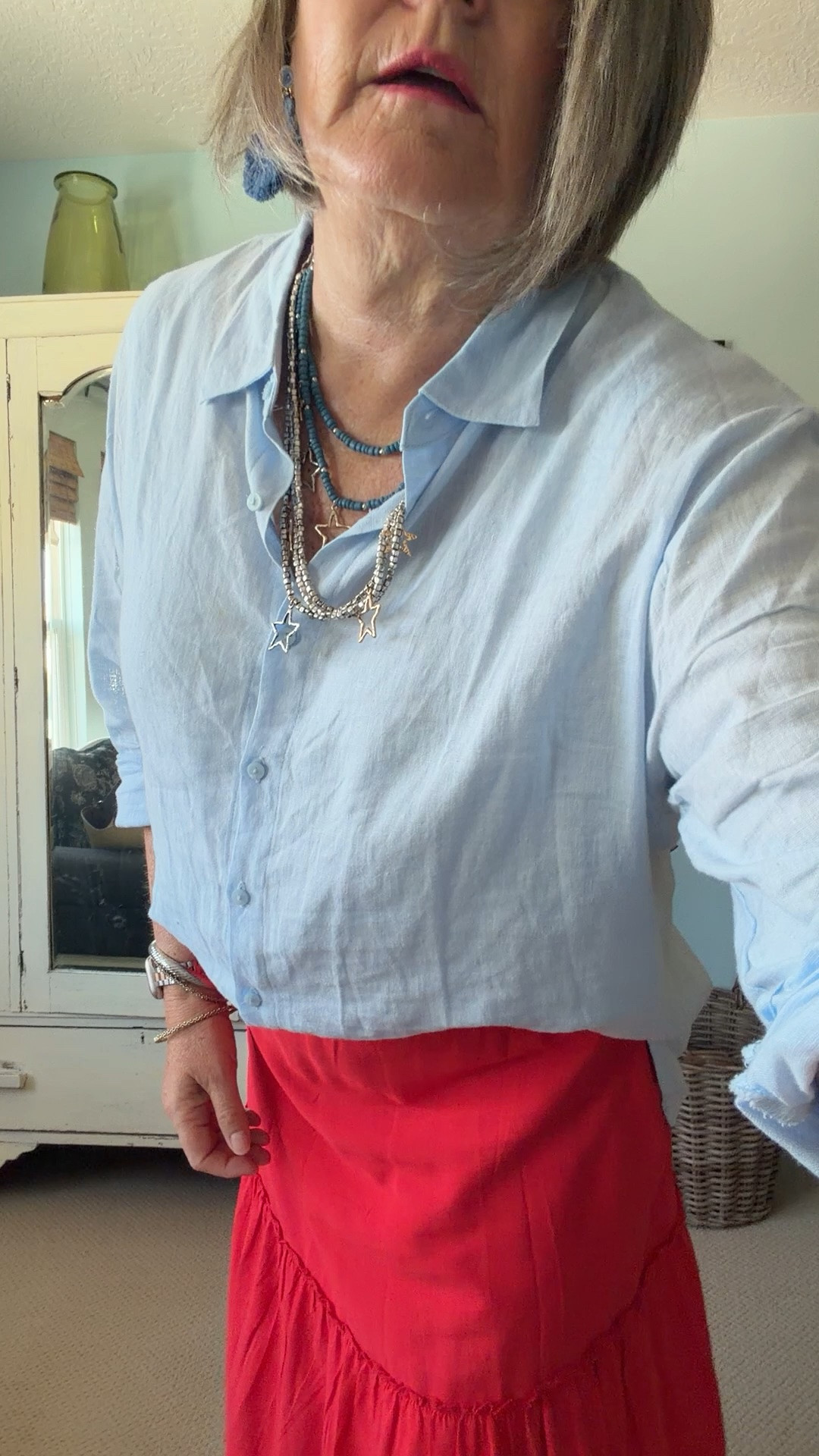 Loving this cute red skirt! I asked Chat AI to help me style this skirt the best way since I have broad shoulders, no waist and a tummy. It suggested a light weight linen blouse, to do a front tuck, leave the long back out, add some cute jewelry and sandals! I love how it looks!

#LTKootd #LTKOver40