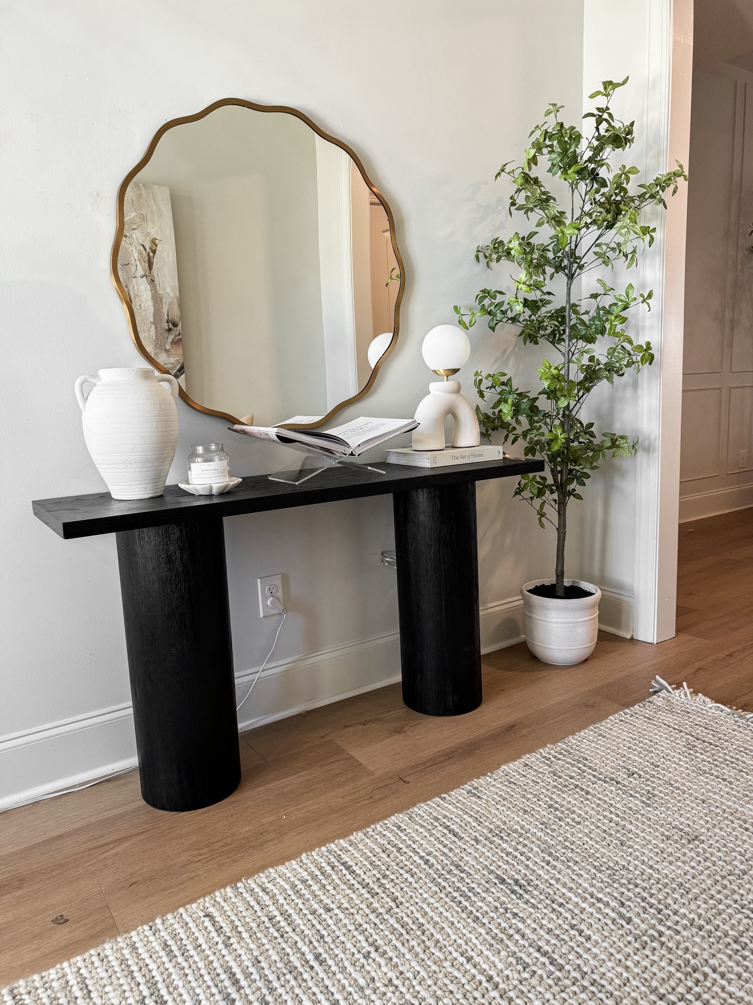 Organic modern entryway for spring 🤎

The console table is sold on Amazon, Target, & Walmart (they’re all the Lana table by Maven Lane). I have all 3 sites linked!

Black console table. Faux tree. Wavy mirror. Organic modern entryway. White vase. Organic lamp. Book stand. Wool rug. Kid and pet friendly  

#LTKhome