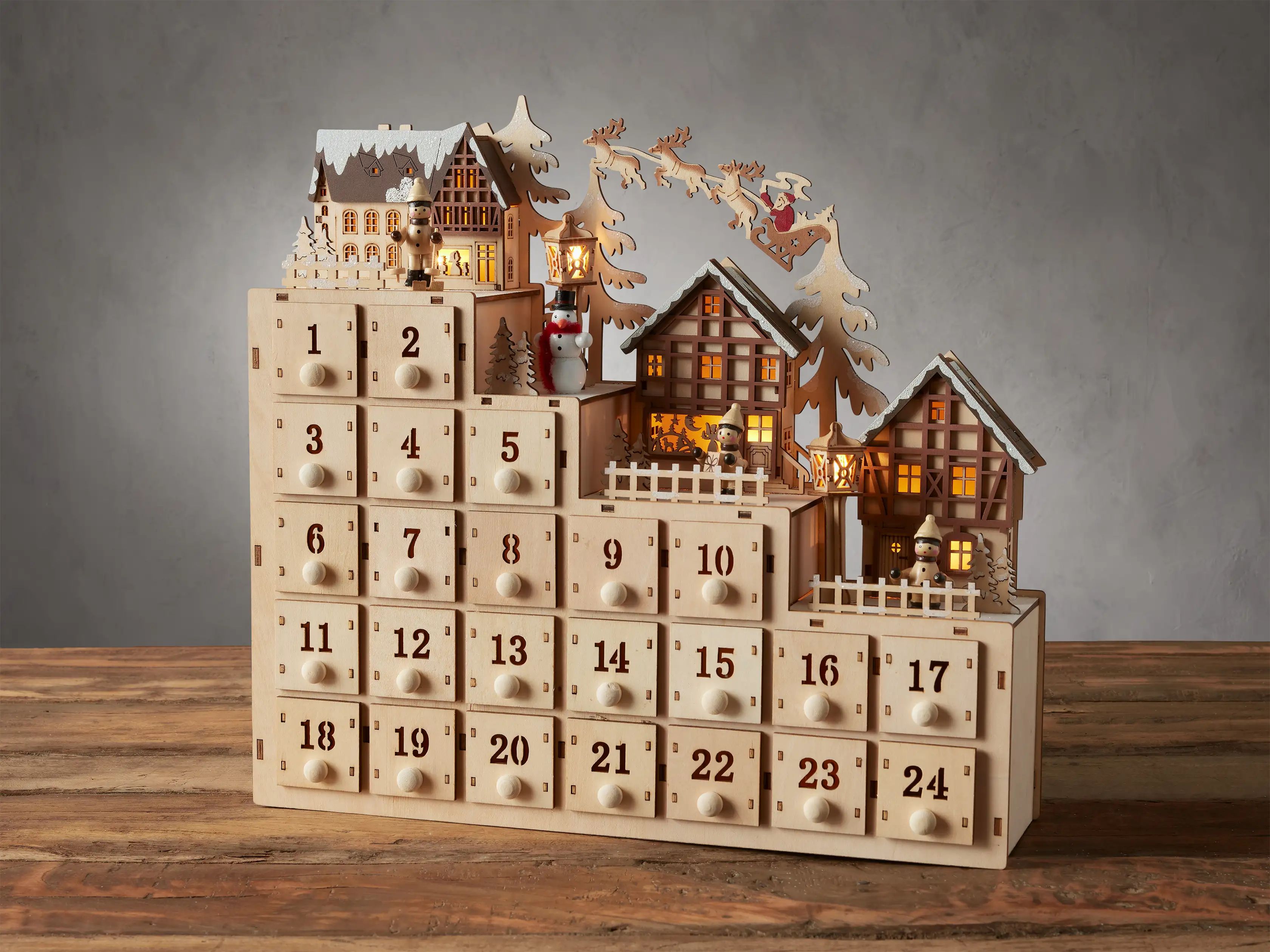 Celebrate every day this holiday season with this charming tiered Advent calendar topped with an ... | Arhaus