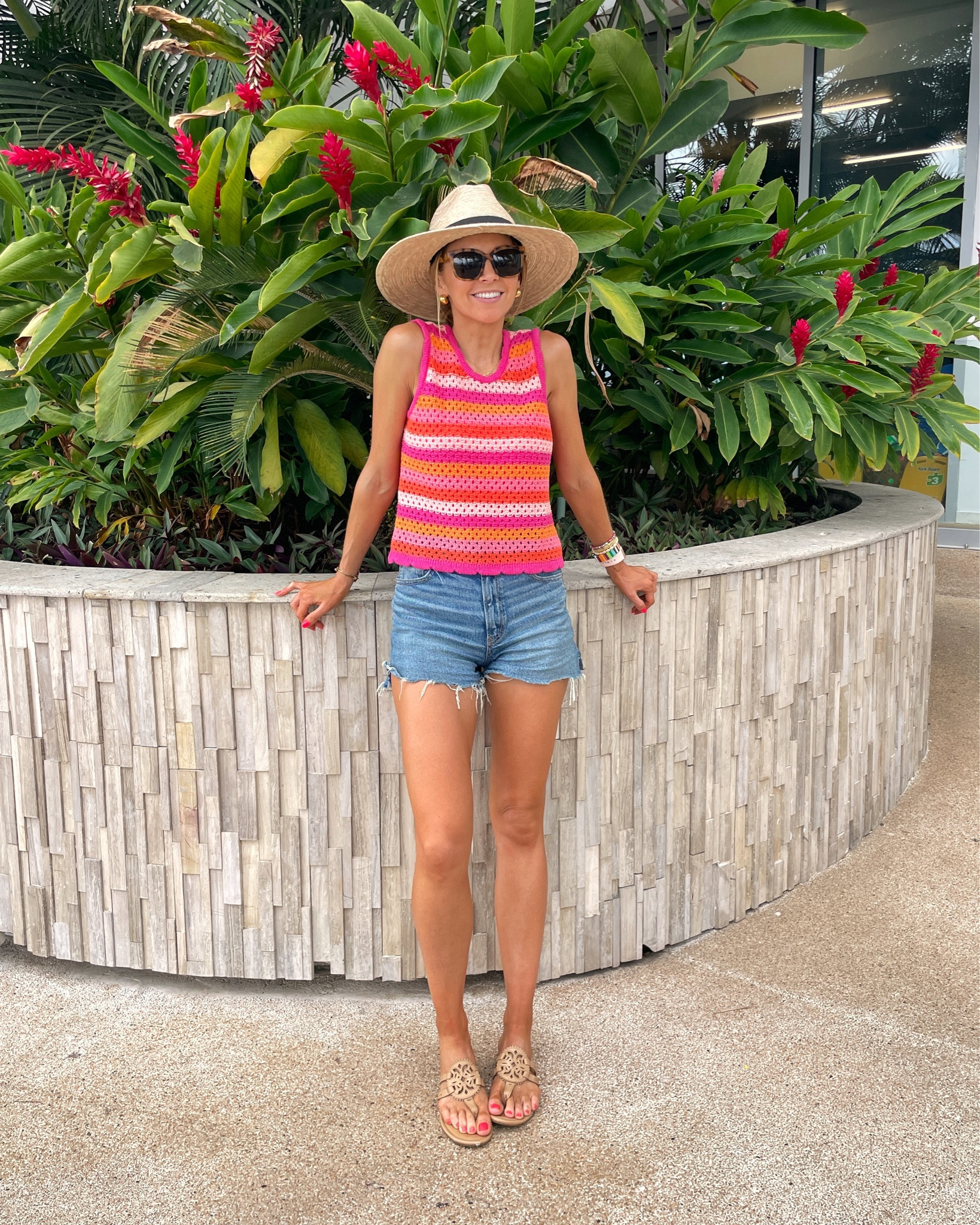 Merrick is wearing a size XS in the tank, 2 in the shorts, and small in the swimsuit. 

The hat is not available but a similar one is linked!