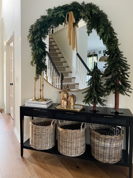 Holiday entryway look: mirror garland, tabletop trees, large bells, primrose tray, candlesticks. 

#LTKHoliday #LTKhome #LTKSeasonal