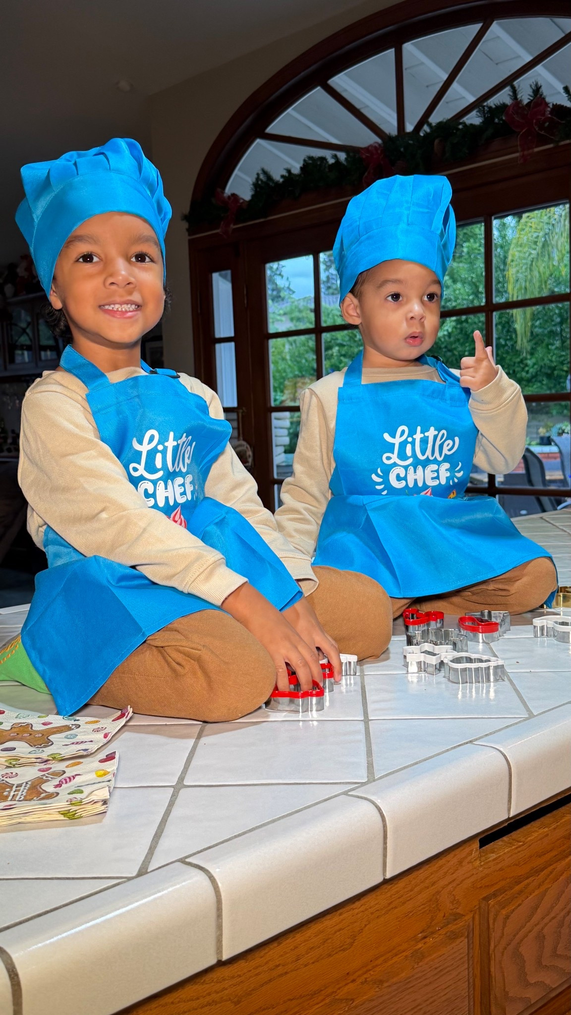 The boys baked gingerbread cookies for the first time with their grandma in these cute apron and chef hat she got them. How cute are they?’ 