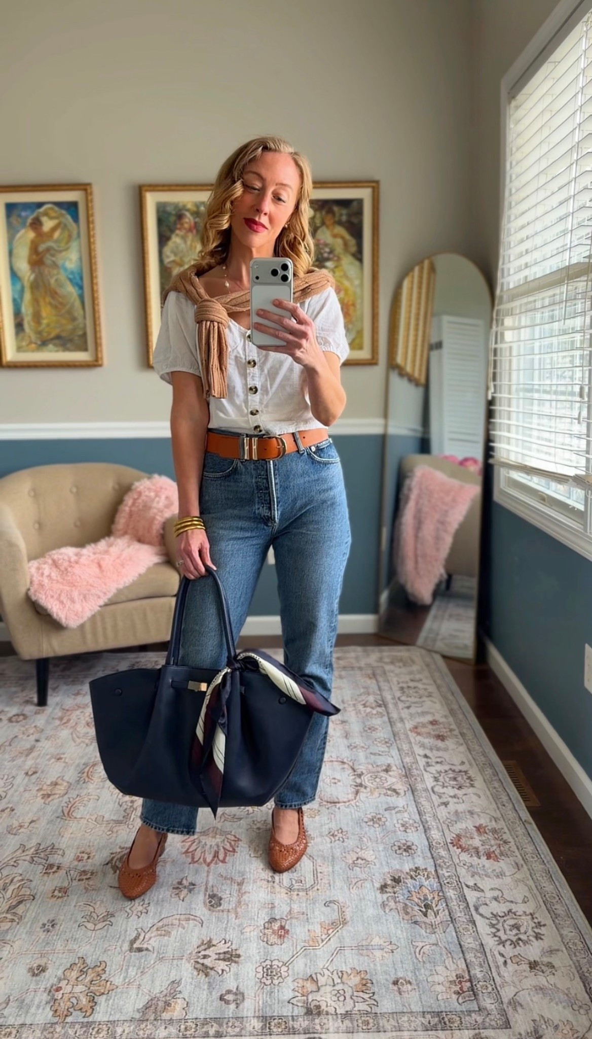 White button-front blouse styled with classic blue jeans, a brown leather belt, woven leather flats, a silk scarf, and a structured navy tote. Sweater thrown over the shoulders too! 

Classic American outfit with an easy, everyday feel.

Timeless, polished style for casual days.


#LTKootd #LTKOver40 #LTKgrwm