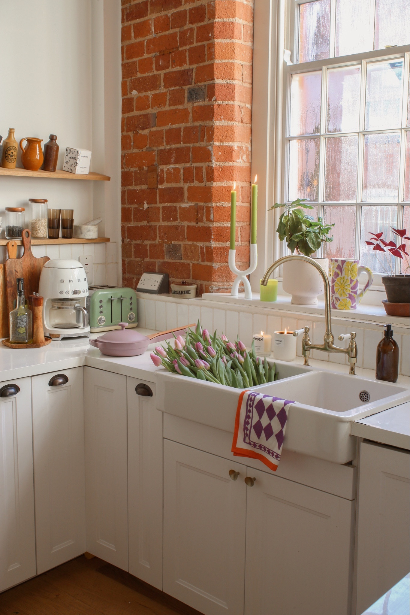 our light, bright and white kitchen with exposed brickwork, white tile and Belfast sink with old factory windows. Converted city apartment with open shelves and white worktops.

#LTKeurope #LTKhome #LTKMostLoved