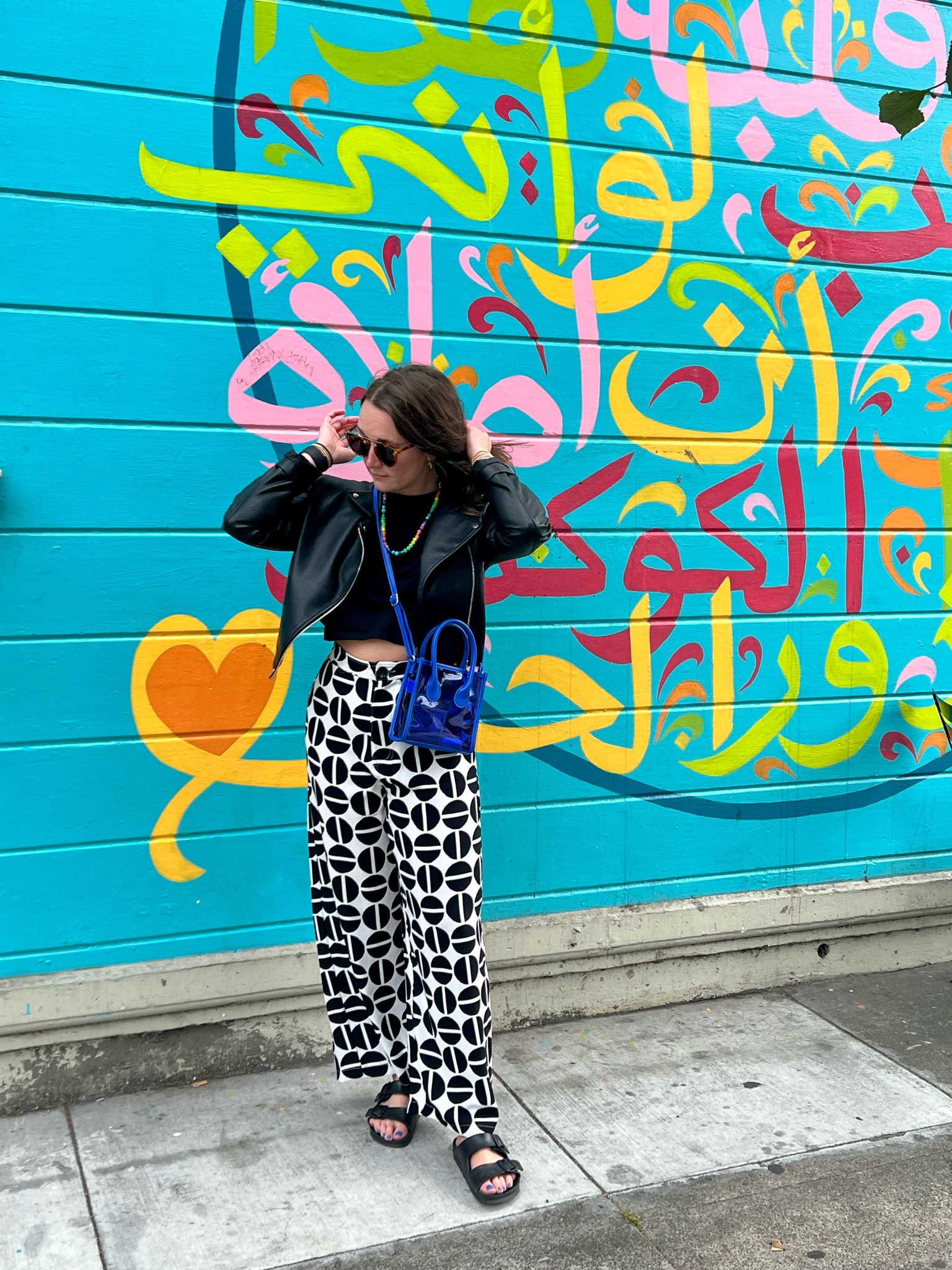 Day 10 of 30 days of getting dressed with what’s in my closet. Wide leg printed pants with a simple top and my tried and true leather jacket. Paired with colorful accessories, I’m loving it. 