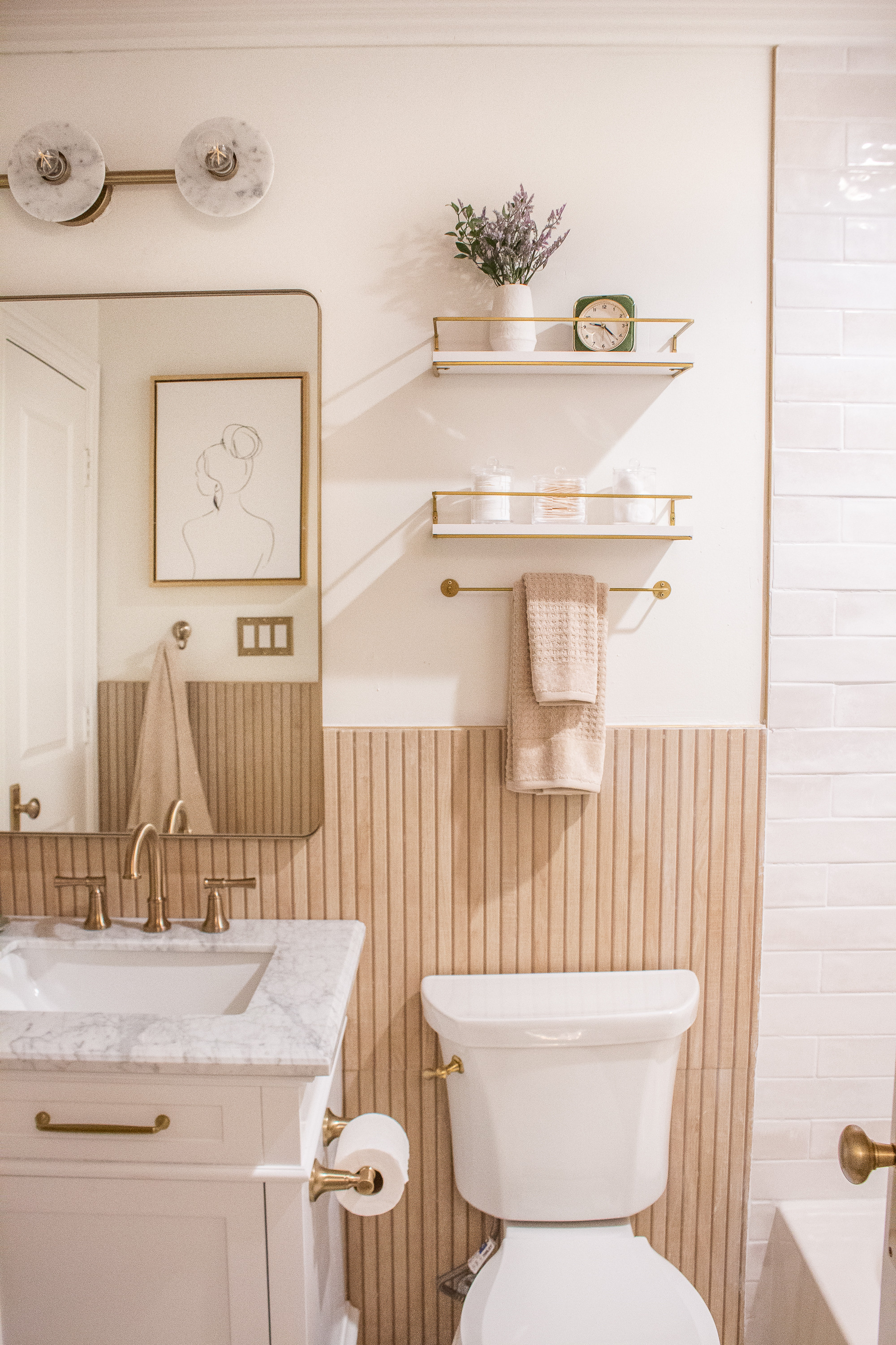 This bathroom makeover feels so warm and inviting with its soft neutral palette and mixed textures. The vertical wood paneling adds depth, the brass fixtures bring a modern touch, and the open wall shelves make it easy to style everyday essentials. The artwork and simple countertop decor tie everything together for a clean, minimal look.
Linking the lighting, hardware, shelving, decor pieces, and similar bathroom accents to help you recreate this cozy, modern space.

#LTKHome #LTKSeasonal #LTKU