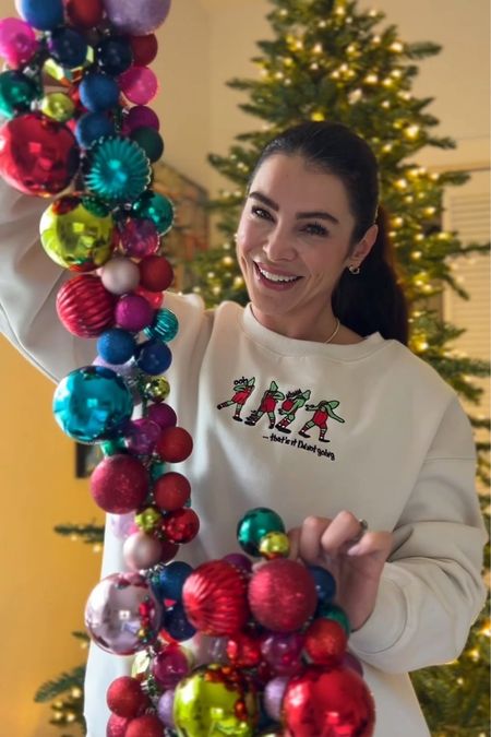 The cutest grinch sweatshirt! I got an XL for an oversized fit. I also linked the ornaments I used to make this ornament garland. #meandmrjones 

#LTKHoliday #LTKfindsunder50 #LTKhome