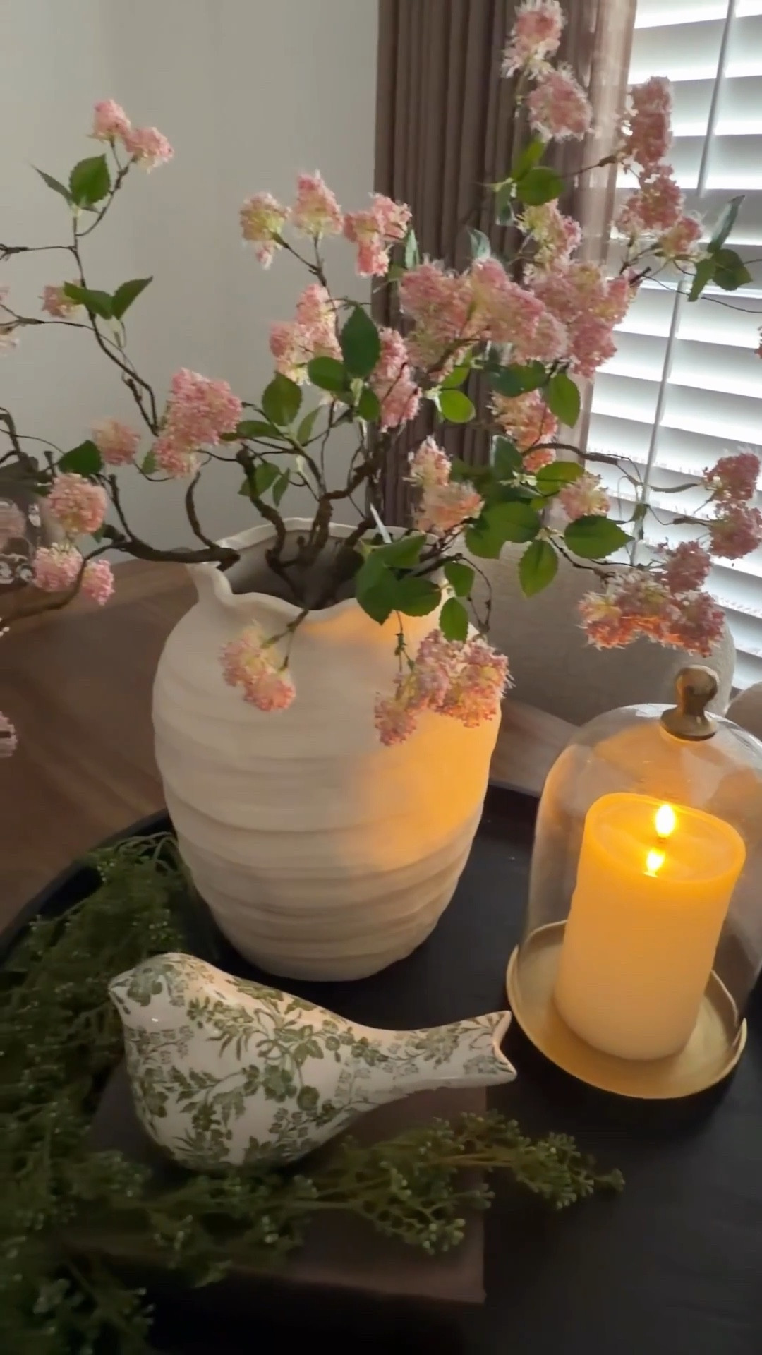 What do you love most about Spring? It’s such a beautiful season! 

This arrangement isn’t just made for Spring. It carries beautifully right into Summer. These whimsical stems bring the prettiest pop of color, and I love how they look styled in my scalloped rim vase. They just work so effortlessly together.

The cloche is one of those pieces I reach for again and again. It’s such a staple for styling. And that green bird? Absolute perfection. 🥰