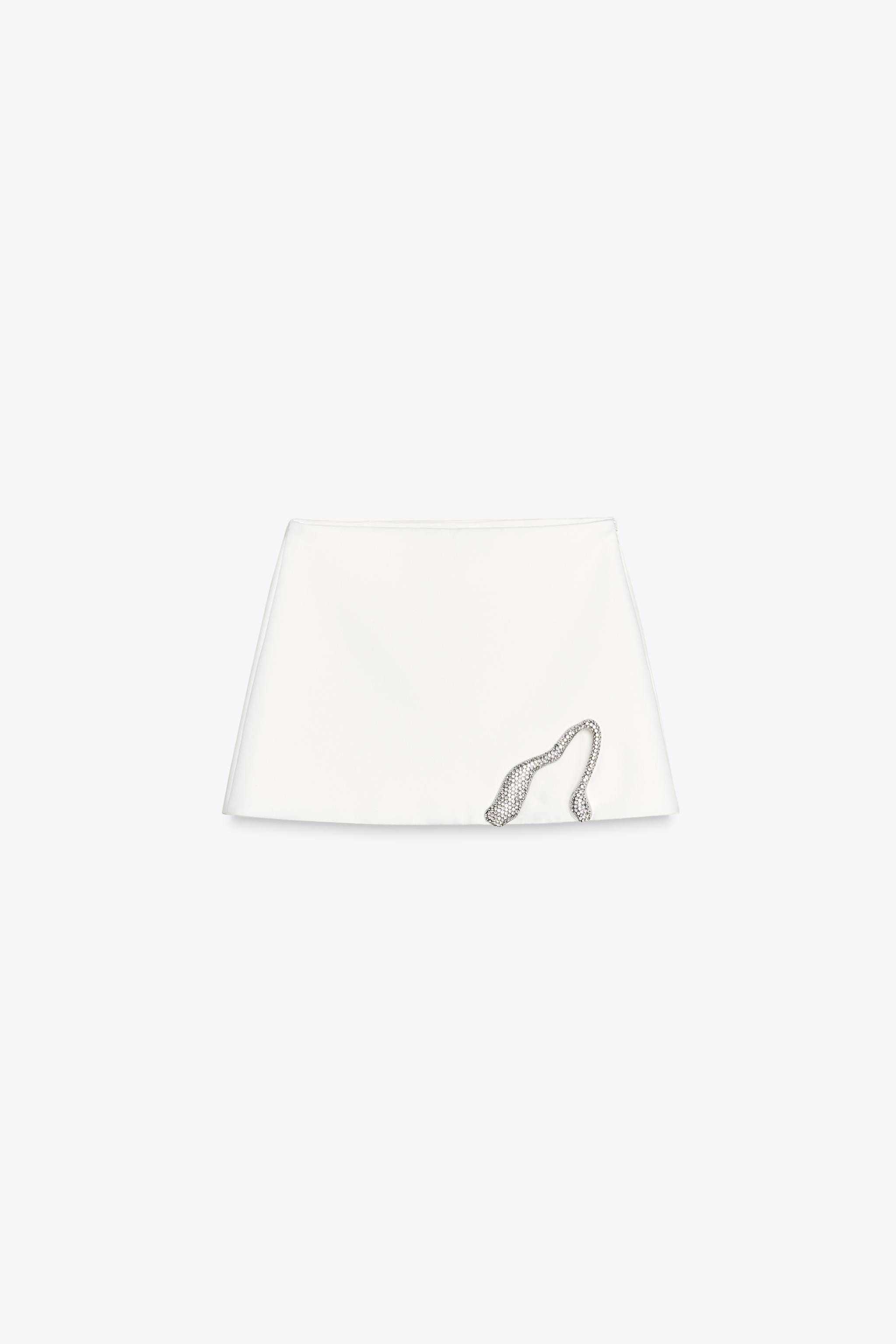 Mid-rise mini skirt. Hem with metal detail and jewel appliqué. Matching inner lining. Side metal... | Zara US