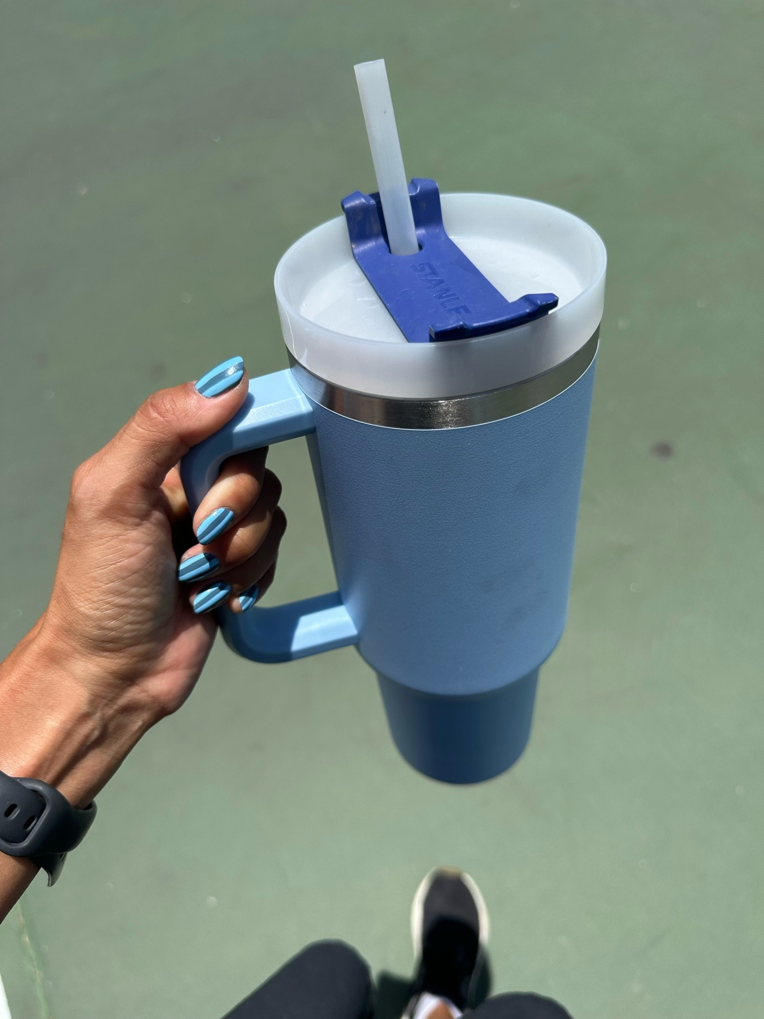 So many things going on here:
• nails 💅 - they matched my water bottle so I had to snap a pic. I do them at home and linked everything I used to this post! I’m really into these summer stripes and they’re easy enough with the liner gel. 
• water bottle - who doesn’t love a Stanley! I like that the handle feels so sturdy vs glass. It also is easy enough to clean and holds a crap ton of water (or Gatorade 😉). I also linked some cute Owalas because I wish I could buy them but don’t have space
• I’m an Apple Watch girl - none of that other stuff
• shoes are my oldies but goodies

#LTKdayinmylife #LTKootd #LTKfitnessgoals