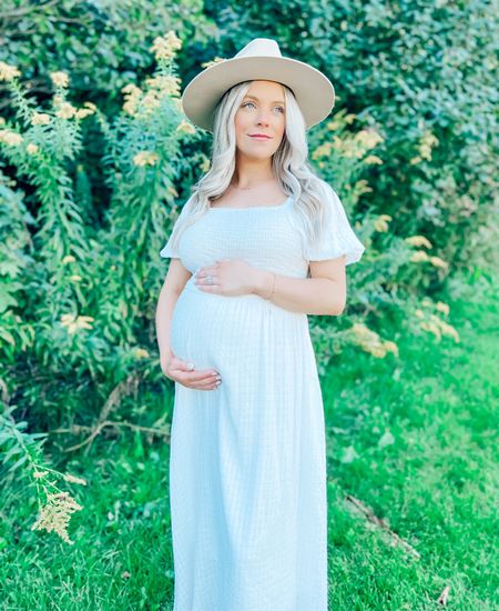 Maternity photoshoot 🤍✨ Wearing a small in the dress! Linked my exact mama necklace on my Insta stories but similar one from Amazon linked here 👼🏼
.
.
.
White dress, white midi dress, pregnancy, bump friendly, maternity dress, maternity photos, wide brim hat, mama necklace 


#LTKstyletip #LTKbump #LTKunder50