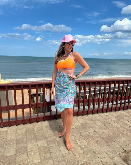 In a medium 2 piece colorful swimsuit, one size sarong, trucker hat, sandals, sunglasses and accessories for spring beach outfit - all fits TTS. 

#LTKswim #LTKstyletip #LTKfindsunder50