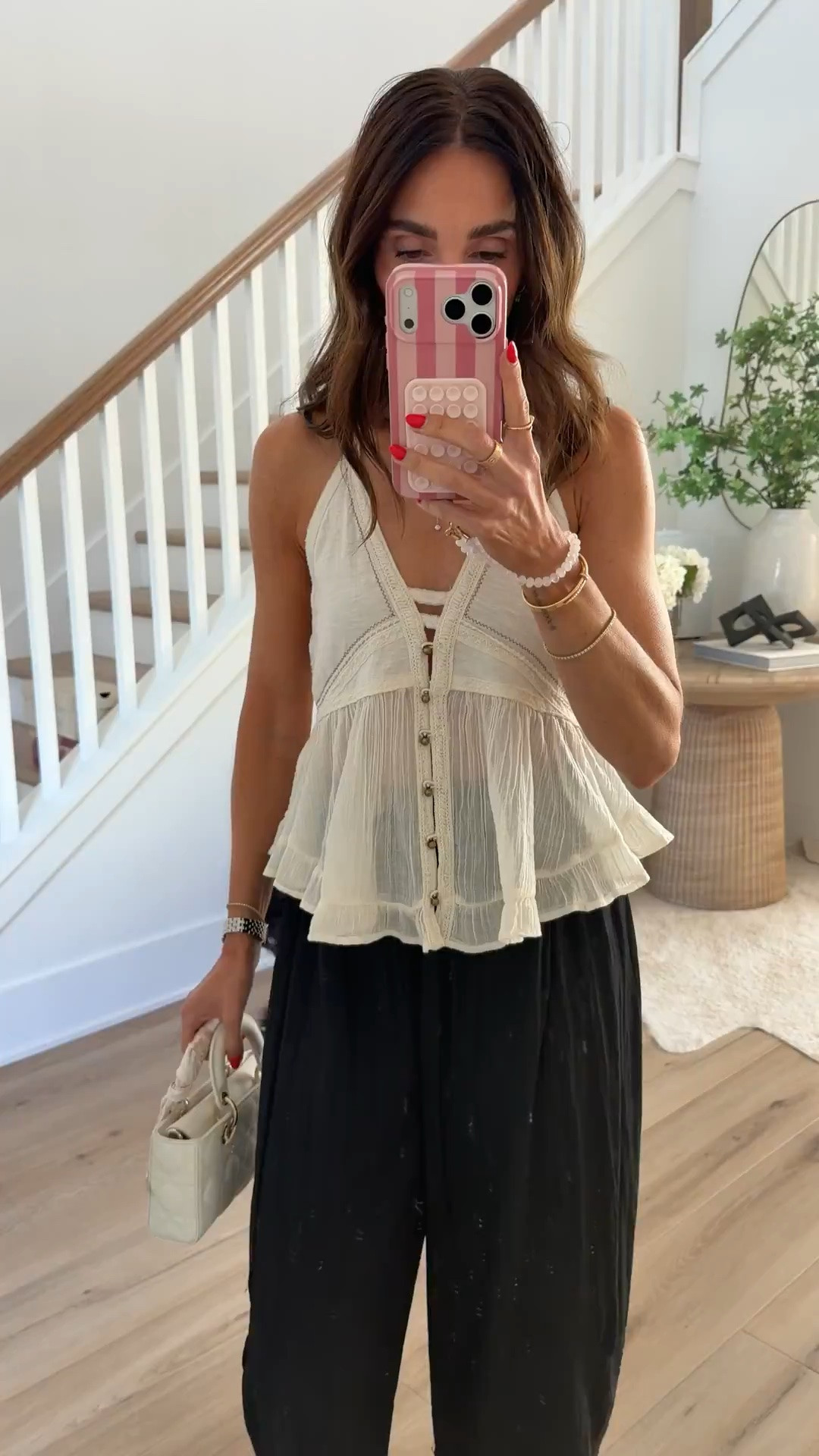 The soft ivory top has a gauzy texture, button front, and ruffled hem that balances the darker wide leg pants beautifully. I love how the lace trim at the ankle gives the black pants movement and makes the outfit feel dressier without losing the relaxed fit.

S pants, XS top

ivory peplum top, lace trim pants, black wide leg pants, neutral summer outfit, boho style, dinner outfit, vacation fashion, flowy pants, feminine details, quilted handbag, annabrstyle

#LTKootd #LTKgrwm #LTKTravel