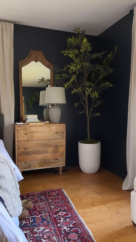 Our main bedroom refresh is starting to come together! Moody bedroom with mango wood nightstand/dresser, tall vintage mirror & 7’ olive tree. 

#LTKhome