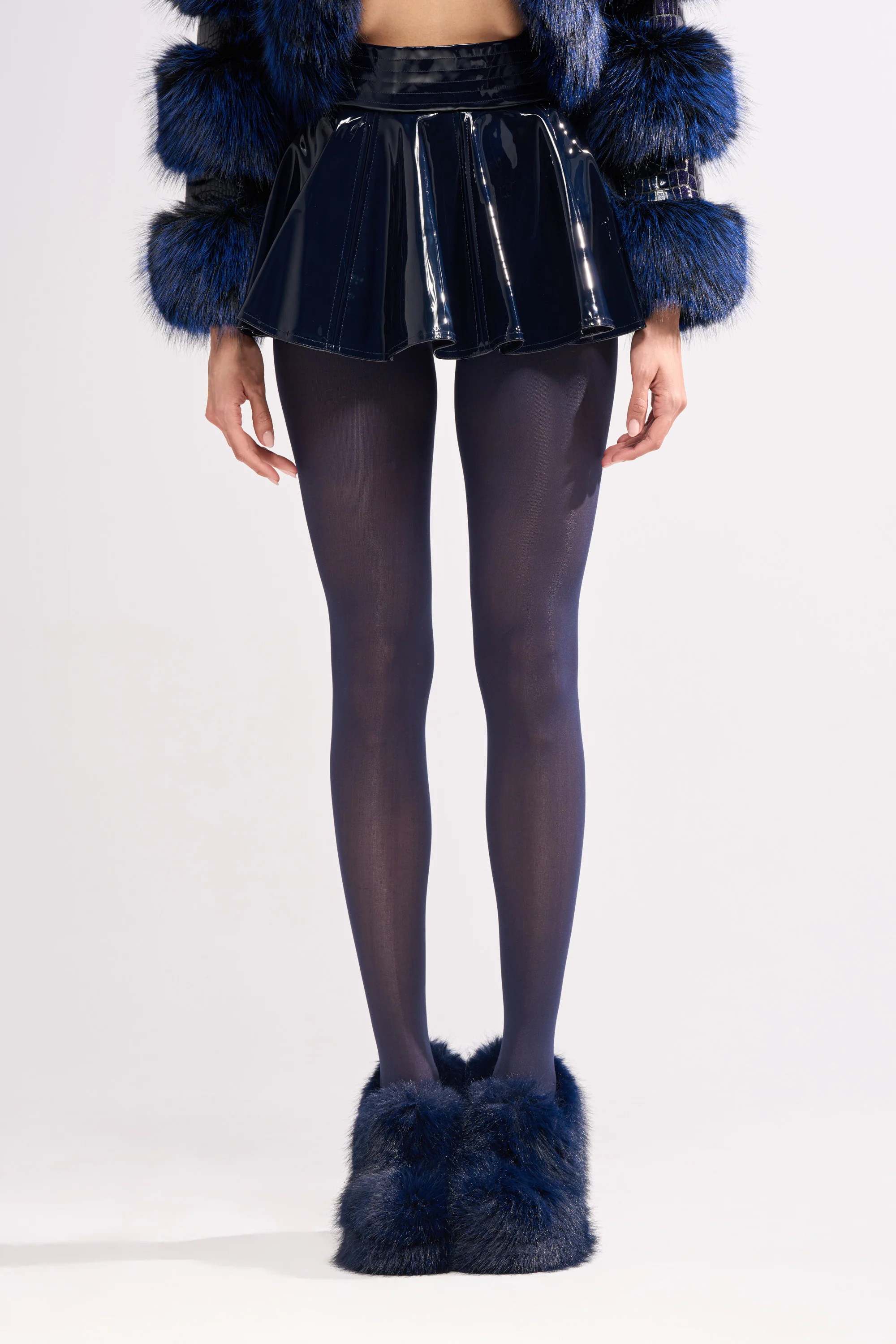 SHE IS ON FIRE FAUX LEATHER MINI SKIRT IN NAVY | AKIRA