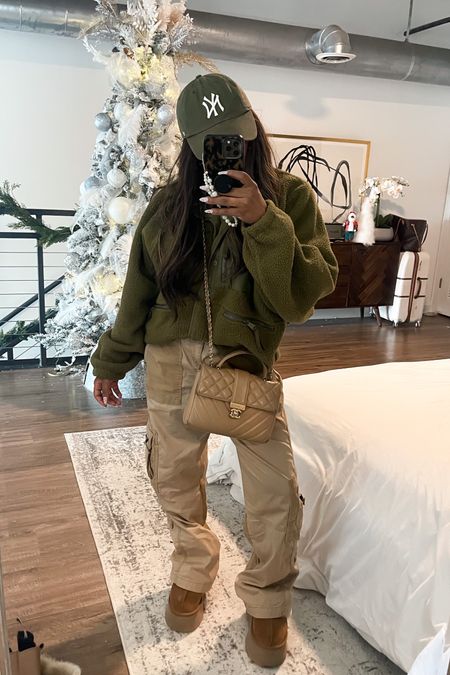 Hunter green tree, people fleece tan cargo pants. Platform UGG slippers travel outfit travel fit. Comfortable outfit. Pearl phone charm. Tortoiseshell phone case. 

#LTKHoliday #LTKGiftGuide #LTKCyberweek