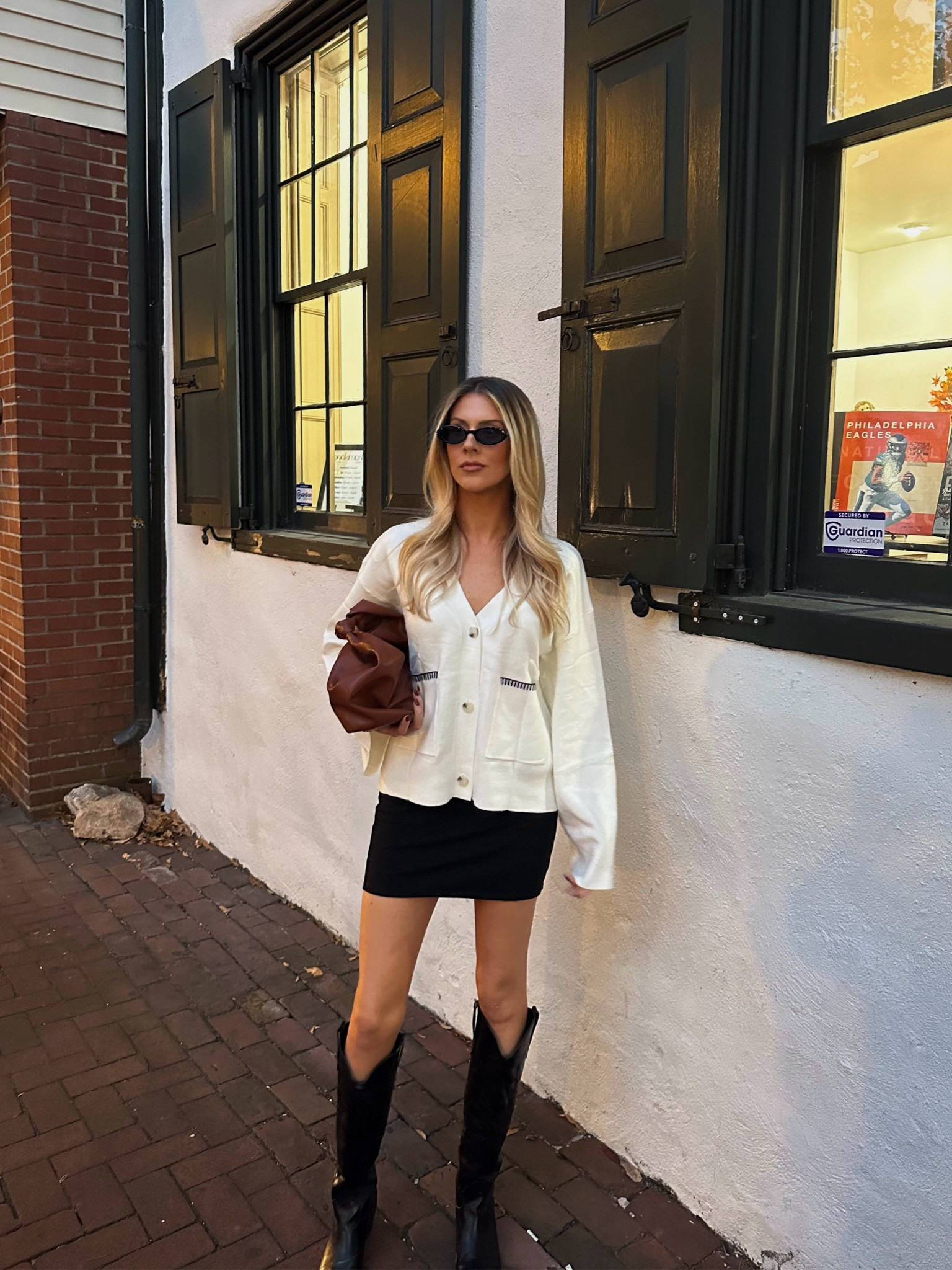 Date Night Outfit, Concert Outfit, Country Concert Outfit, cream sweater, v neck, v neck sweater, varsity sweater, Amazon outfits, Amazon sweater, cream and black outfits, black boots, boots for fall, cowboy boots, fall bags, bags for fall, chestnut colored bag, black mini skirt, fall outfit inspo 🕯️

size L in the sweater! 

#LTKStyleTip #LTKFindsUnder50 #LTKSeasonal