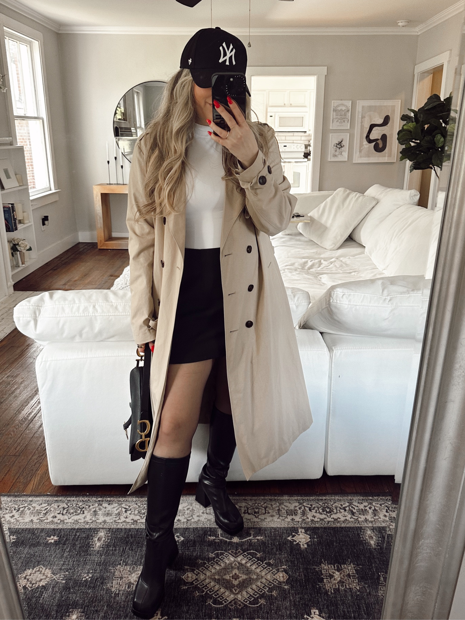 Classic winter outfit - white tee, classic trench, skort, baseball cap and chic polished super affordable go go boots 

#LTKstyletip #LTKSeasonal