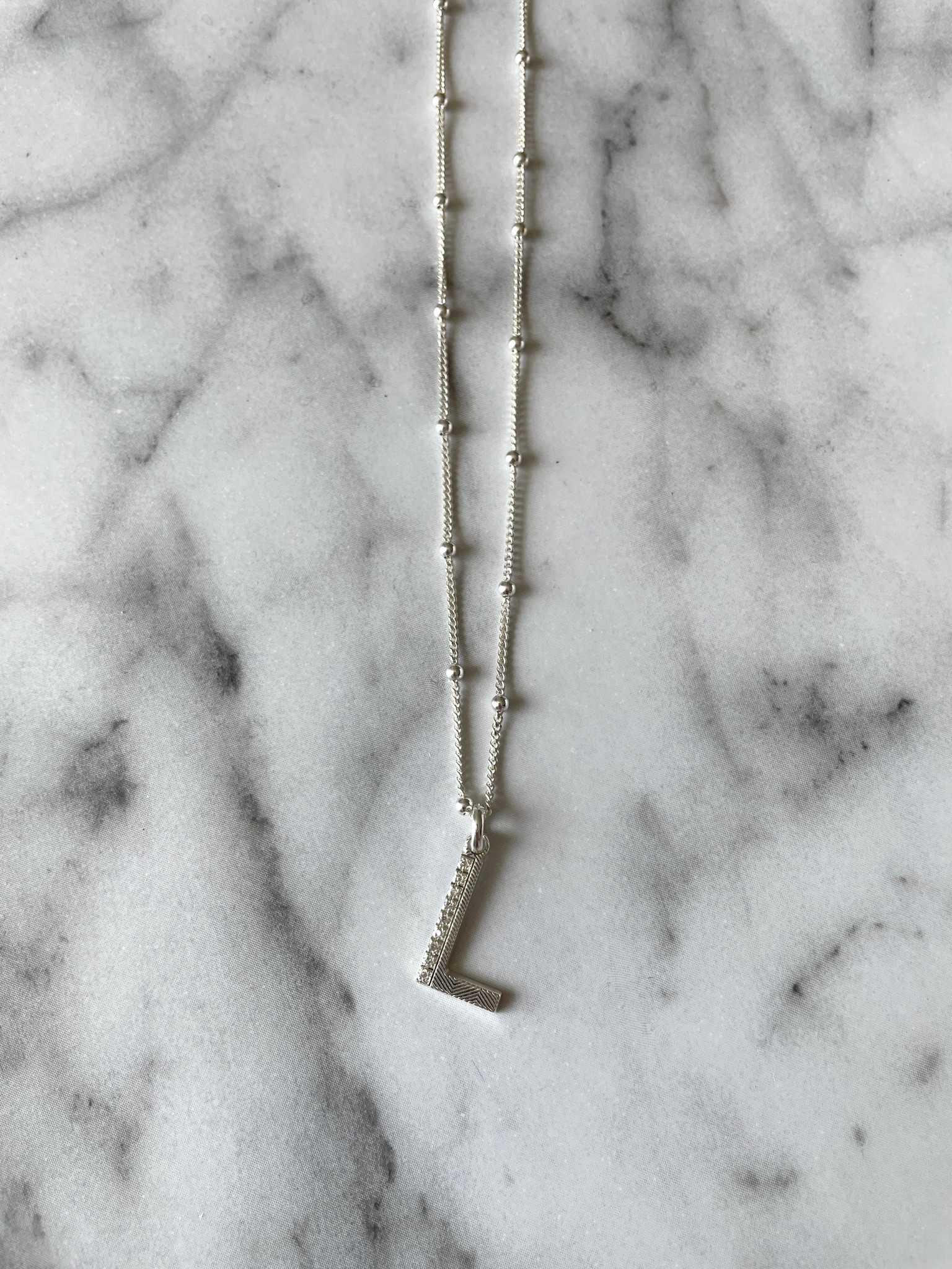 Radiate luxury with this texture initial diamond necklace ✨ I have it in the 18” to layer with shorter necklaces to create dimension. I love the bobble chain that’s unique to others and the diamonds on the letter. You can choose from different lengths for the chain and either gold or silver. Would make a lovely personalized gift 🎁  Use code: JULY15 for 15% off. 

Initial necklace, personalized necklace, jewelry, gold jewelry, silver jewelry, personalized jewelry, personalized gifts, gift guide, gift ideas, sale, The Stylizt 



#LTKSaleAlert #LTKWedding #LTKStyleTip
