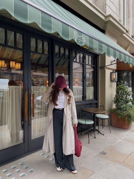 Burgundy cap, white t-shirt, trench coat, wide leg trousers, suede trainers, leather gold belt, leather criss cross tote bag

#LTKstyletip #LTKSeasonal #LTKeurope