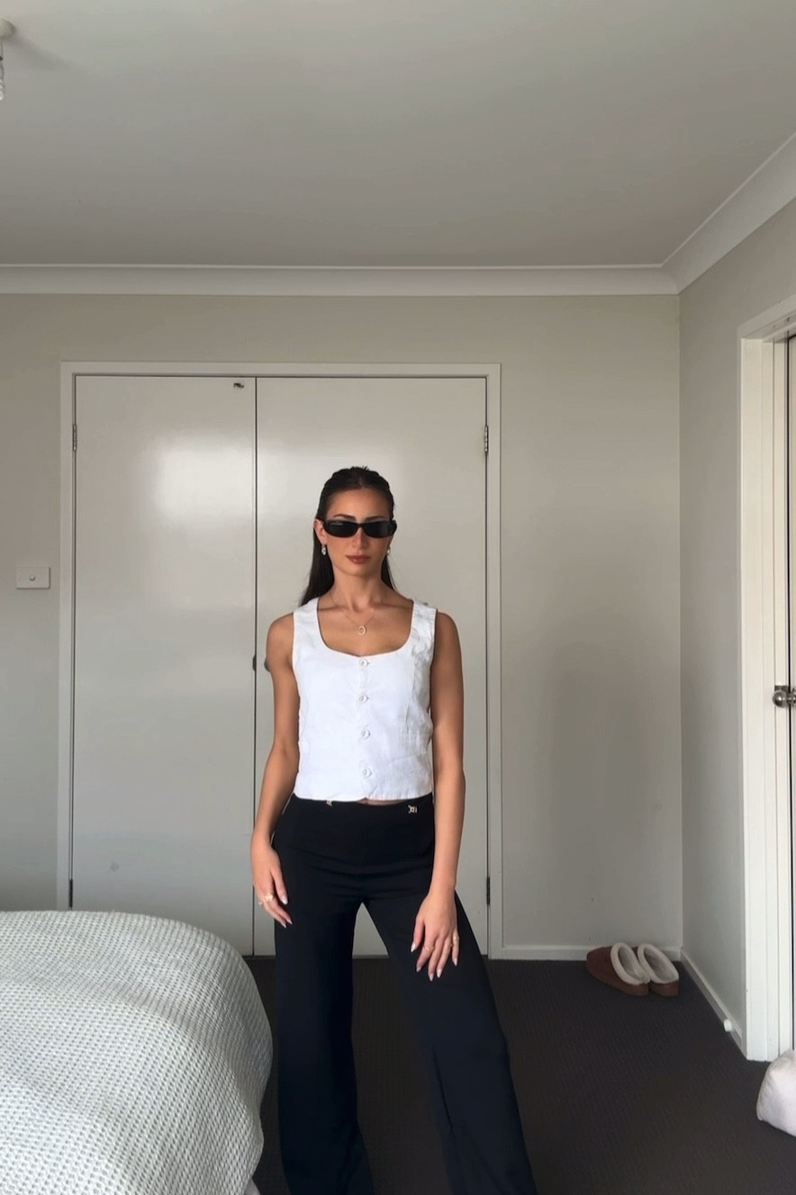White Vest linen top from DISSH (AU 6) and black pants from Kookai (AU 6) paired with a black kitten heel (EU 37). 

#FashionMonth #LTKaustralia #LTKspring