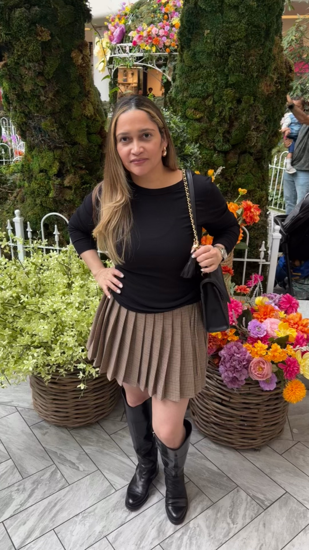 This effortless yet chic fall outfit features a basic long-sleeve t-shirt, plaid pleated skirt, knee-high boots, a purse, and gold accessories.

#LTKootd #LTKSeasonal #LTKOver40