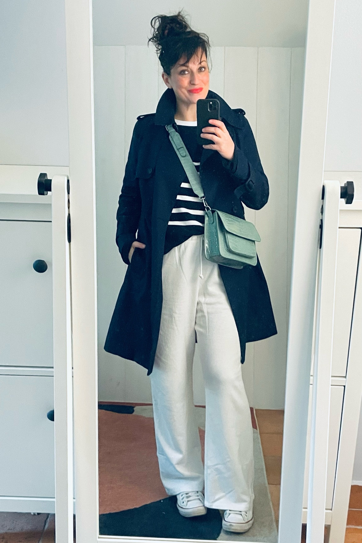 . Navy trenchcoat #comptoirdescotonniers 
. Men heavy cotton white tshirt #fruitoftheloom (linked) 
. Navy striped 3D knit #uniqlo (linked) 
. White flare sweatpants #hm (linked) 
. Mint green crossbody bag #hvisk 
. "Defiant coral" semi-matte lipstick #esteelauder (linked) 
