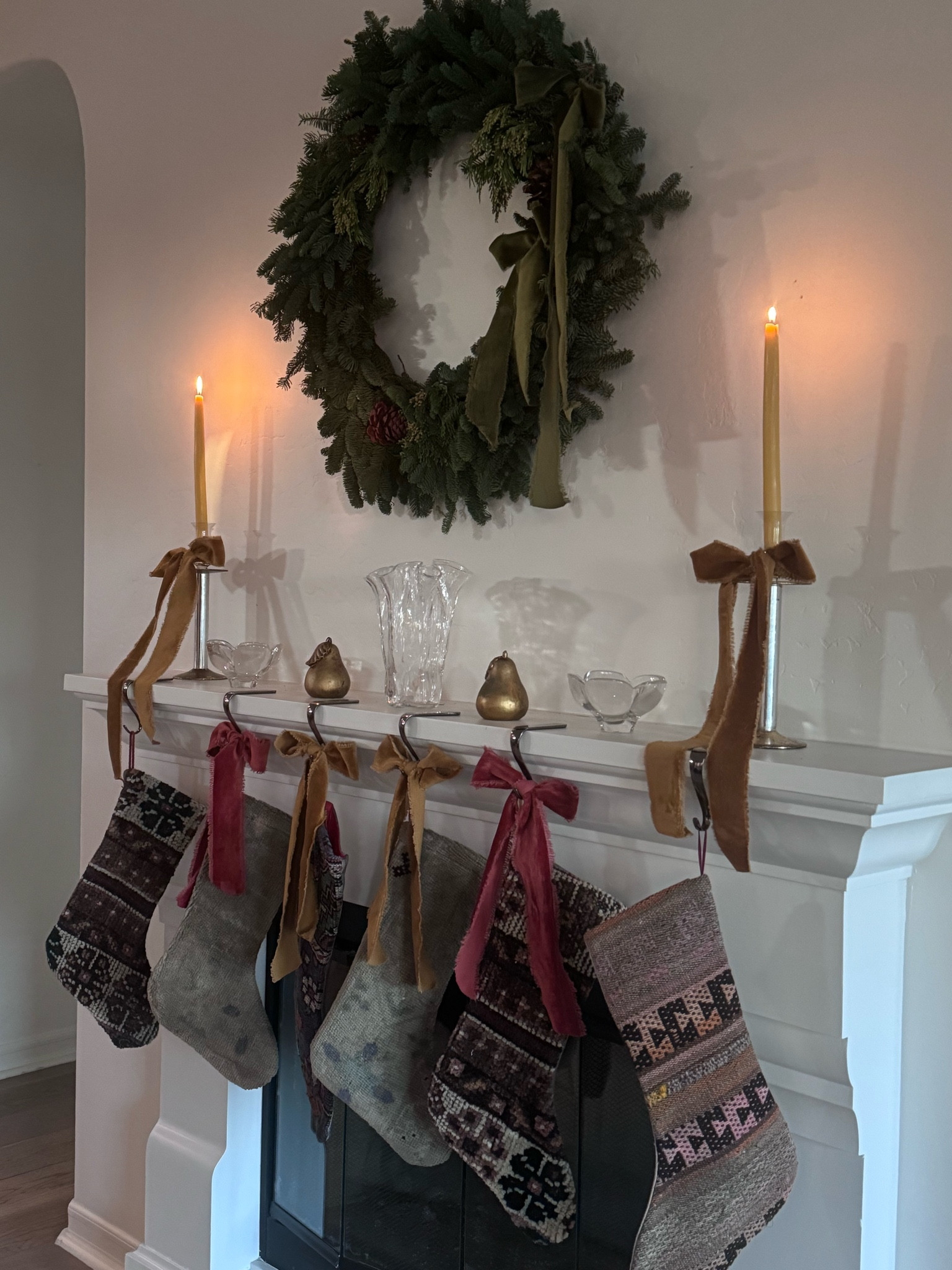 Christmas Mantel Decor 
Handmade stockings + Velvet bows + vintage Glass Bowls+ beeswax candles  🕯️ 
@olgasabode 

#LTKSeasonal #LTKHoliday #LTKHome