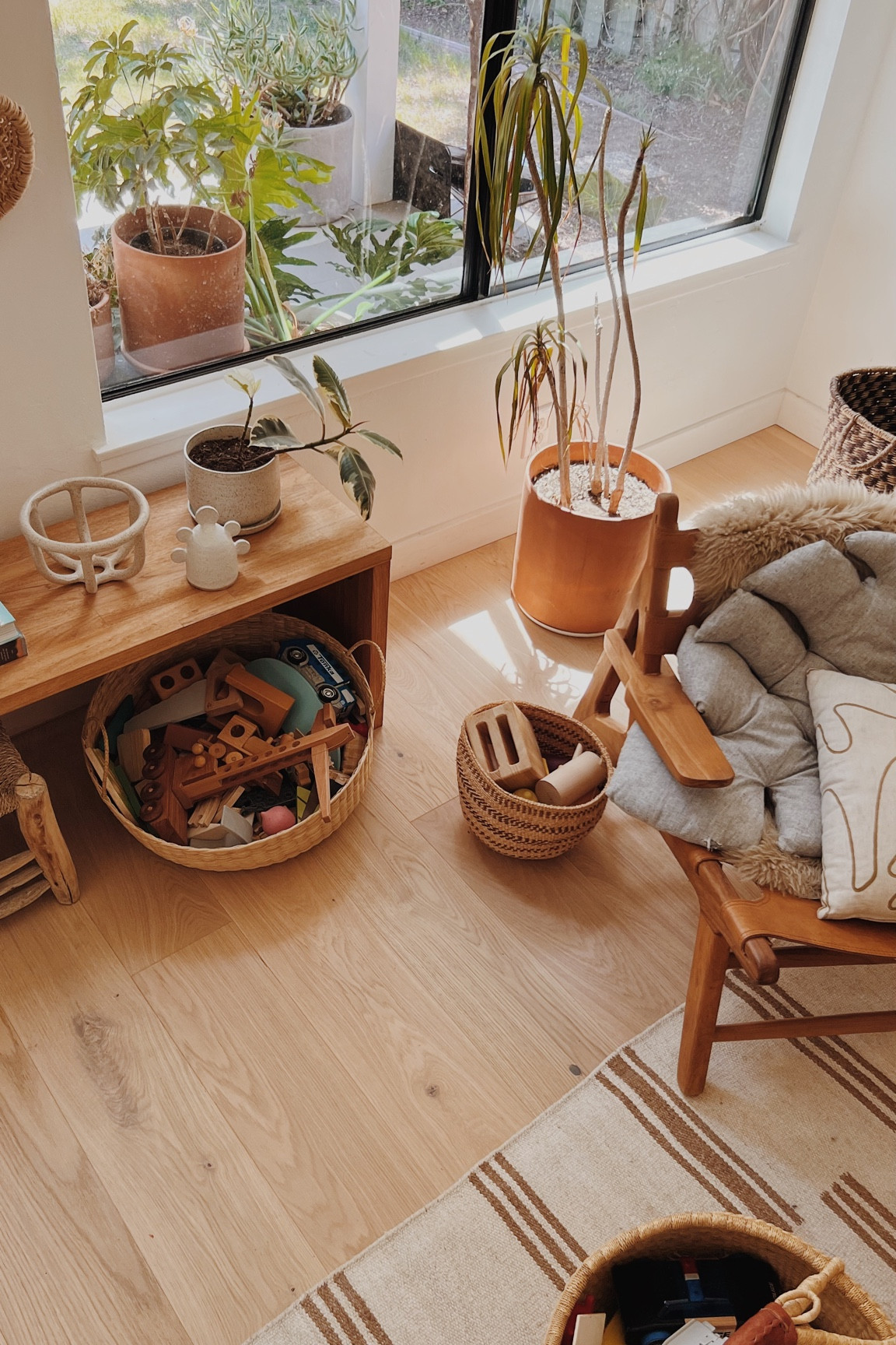 As someone with very little closet / hidden storage, I have baskets everywhere for quick cleanups with toys and stuff. Living room - organic modern - leather chair - striped rug - terracotta planter - storage idea

#LTKFind #LTKhome #LTKfamily
